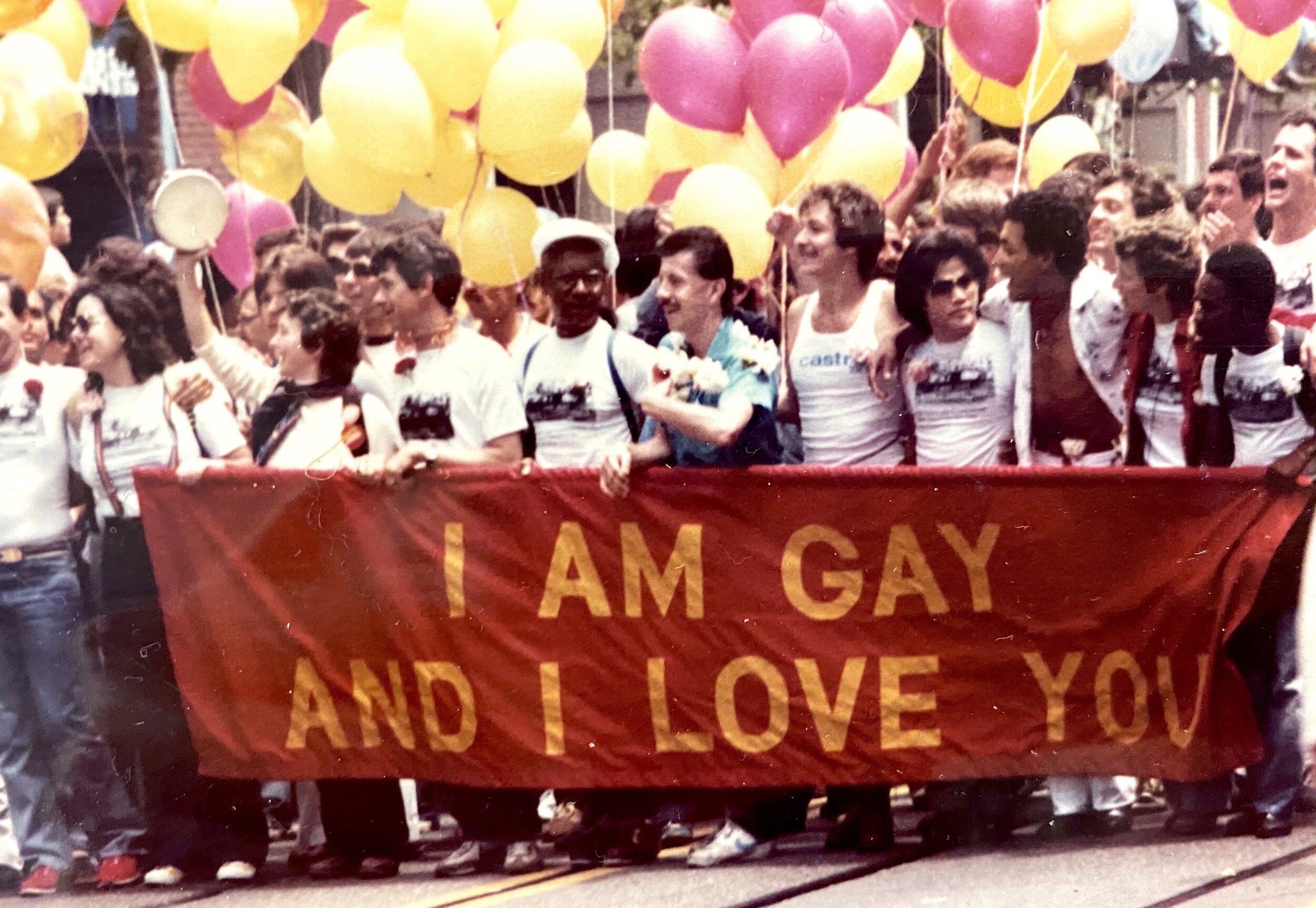  People marching with balloons and a banner that reads “I am gay and I love you,” Gay Freedom Day Parade, 1979; photograph by Ken Hamai, courtesy of photographer, all rights reserved. 