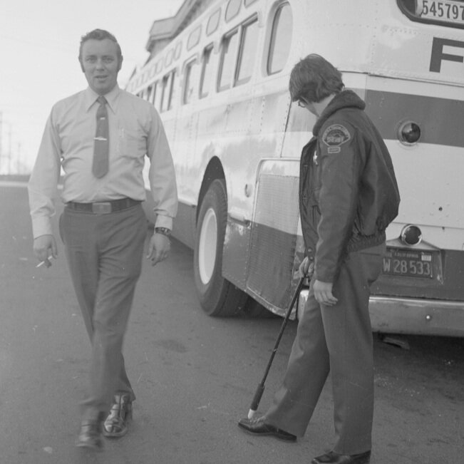 Officer inspecting gay day trip bus, 1974 