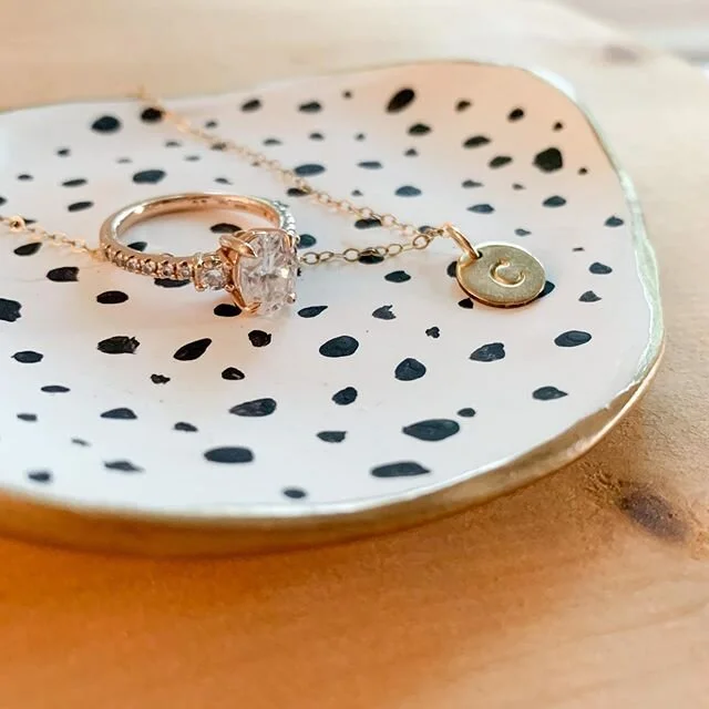I keep a trinket dish on my bedside table &amp; one on the ledge above my kitchen sink.