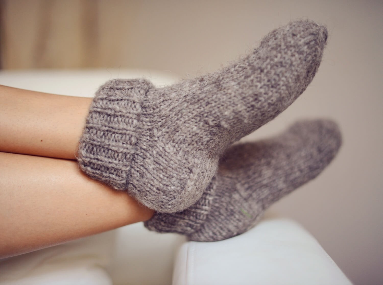 Feet in warm wool socks resting during an acupuncture for IVF treatment