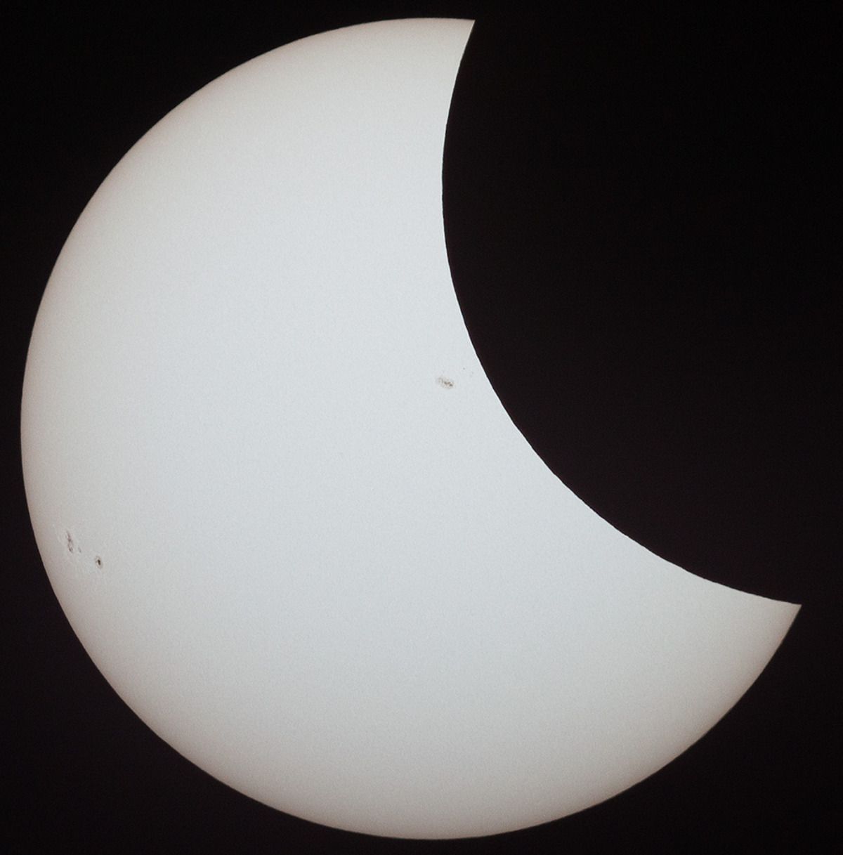 Partial Eclipse featuring sunspots 2671 and 2672