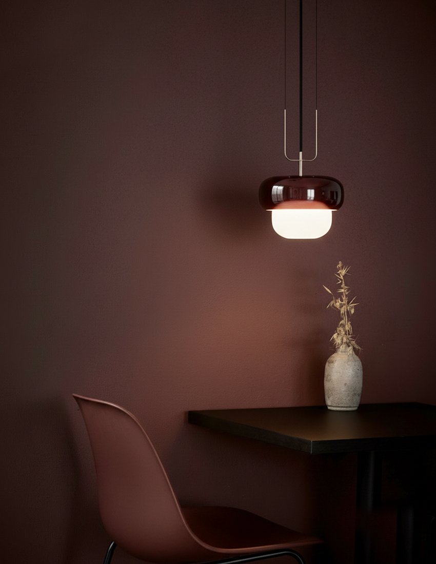 Slender metal supports extend upward, reinforcing a sense of vertical balance while maintaining visual lightness. Their fine profile contrasts with the rounded central mass, creating a dialogue between precision and softness. 