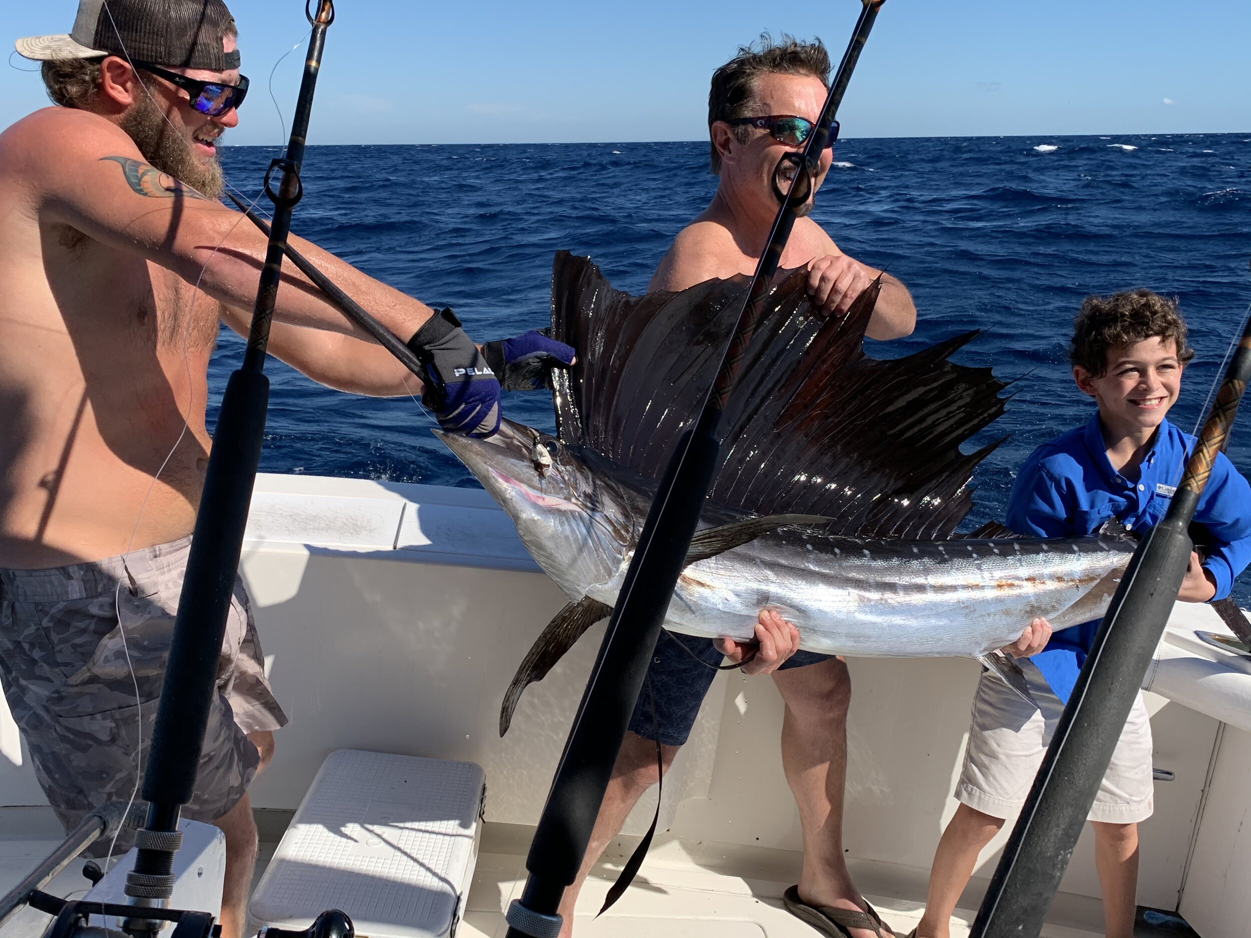 Howard's Grandson, Tripp, catching his first sailfish, which was measured and released.