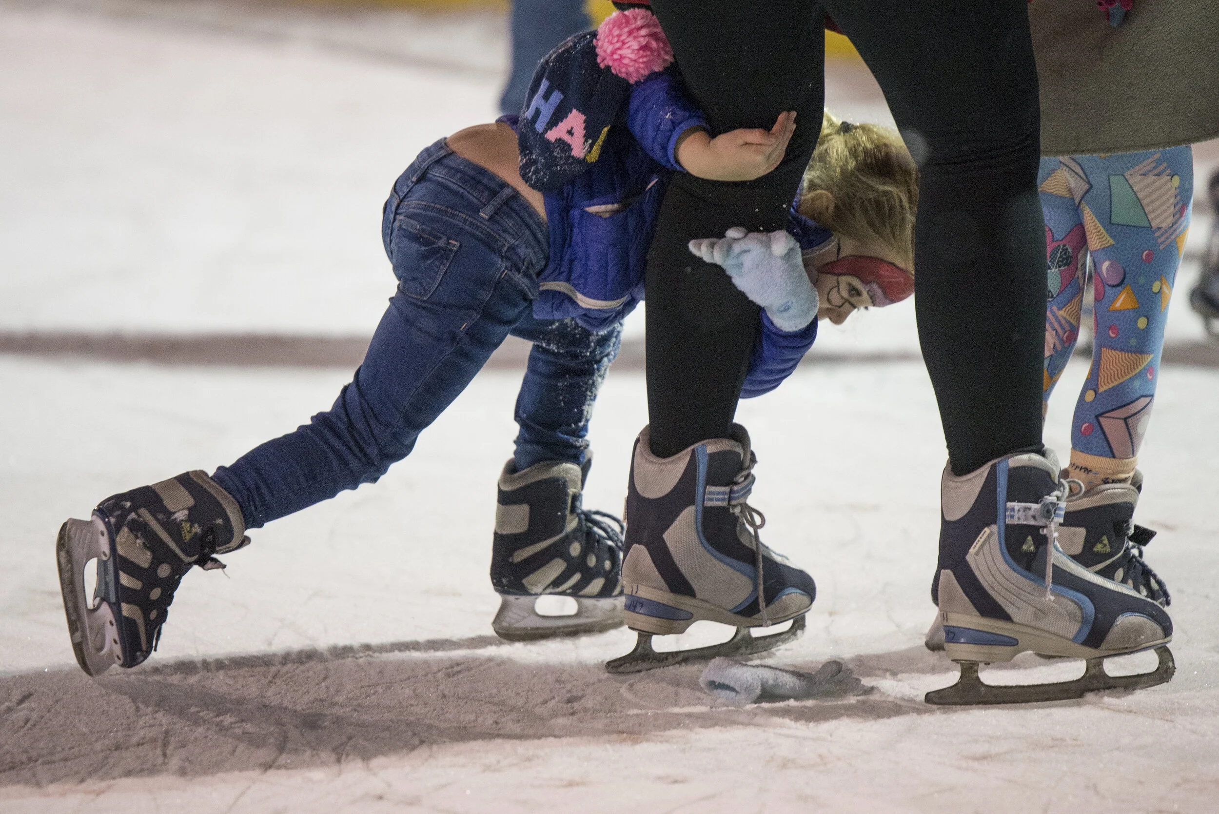  Girl clutches onto her mother's legs while ice skating on Worcester Common Oval during the annual Worcester Festival of Lights on Friday, December 6 2019. 