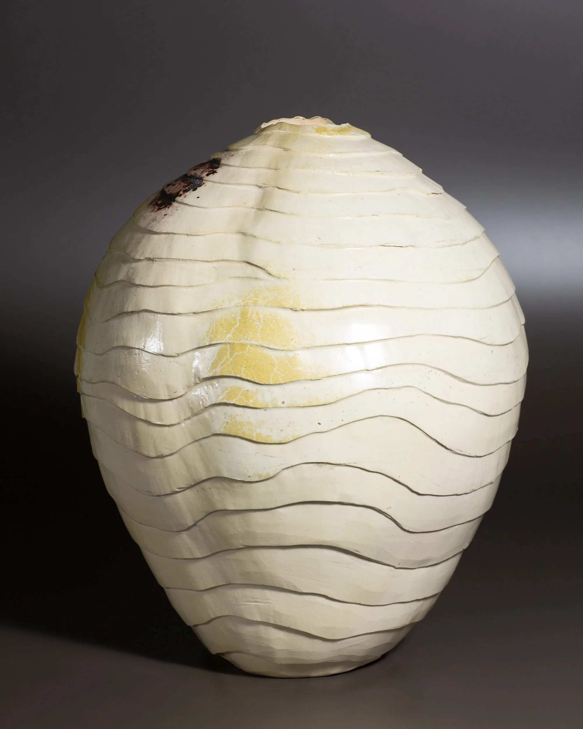   Carved vessel, white with manganese marks   13.75” d, 16.75” h  ID: 2007 