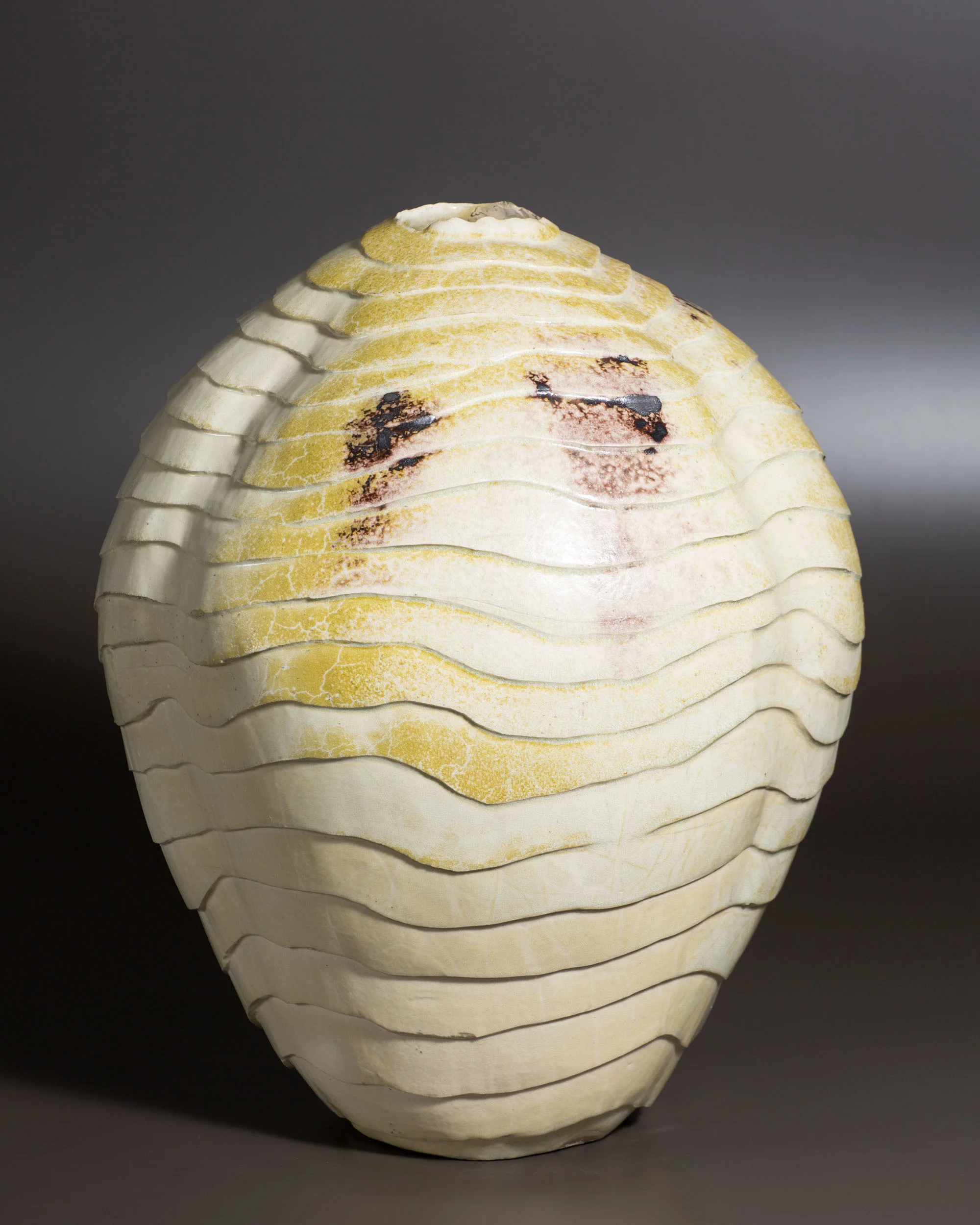   Carved vessel, white with manganese marks   13.75” d, 16.75” h  ID: 2007 