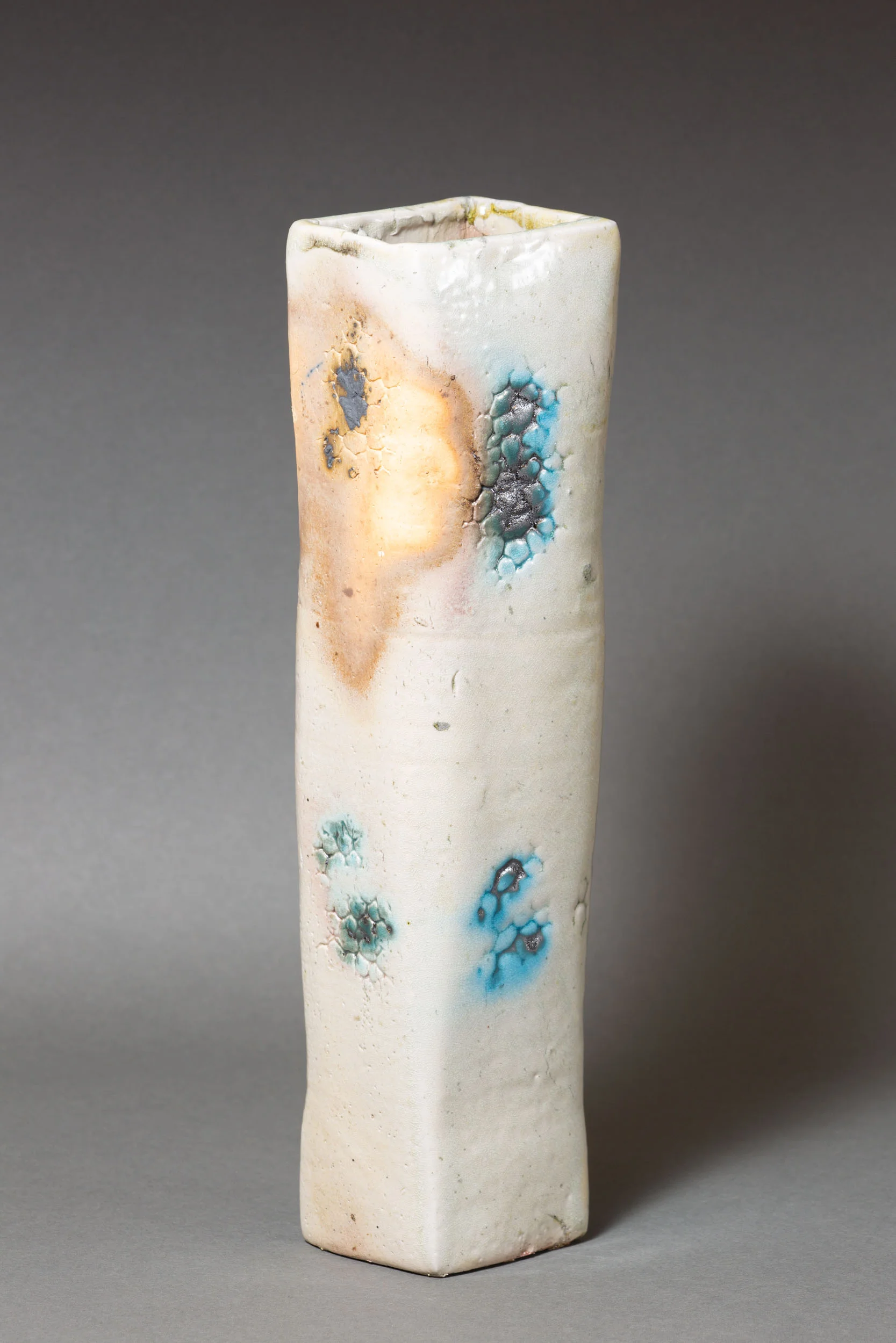   White rectangular vase with coral impressions and copper accents    3 ” x 2.5” x 12”  ID: 5007  SOLD 