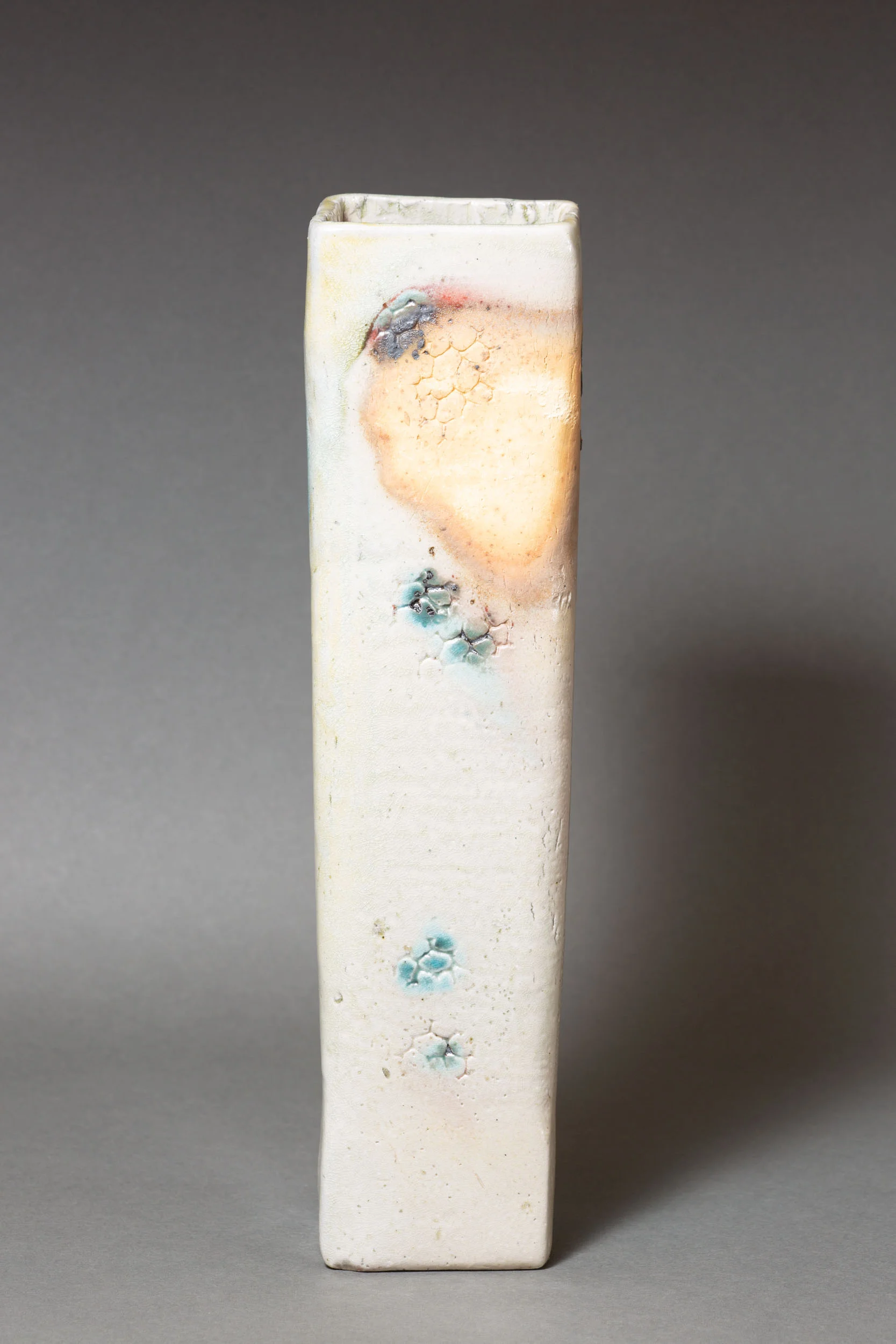   White rectangular vase with coral impressions and copper accents    3 ” x 2.5” x 12”  ID: 5007  SOLD 