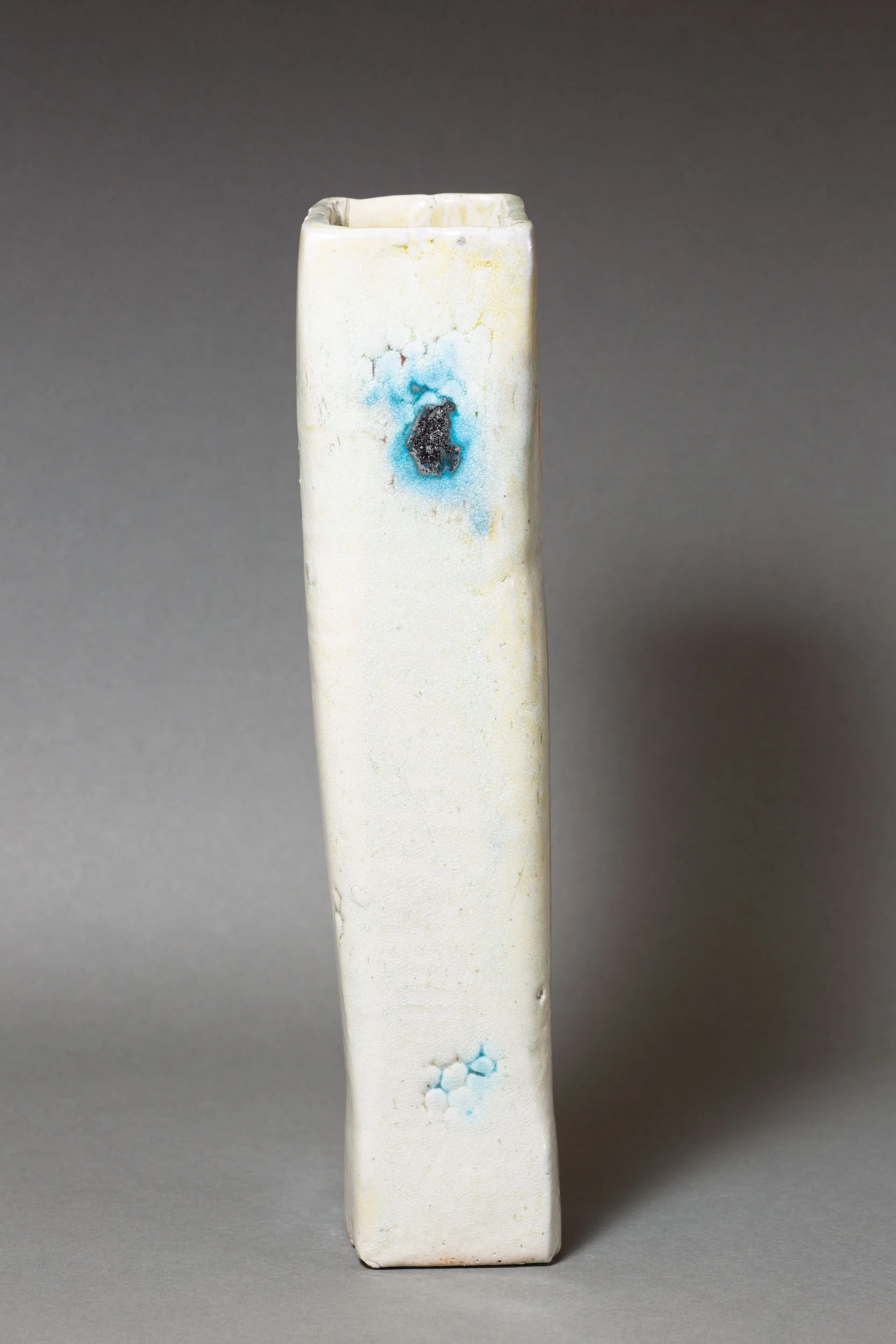   White rectangular vase with coral impressions and copper accents    3 ” x 2.5” x 12”  ID: 5007  SOLD 