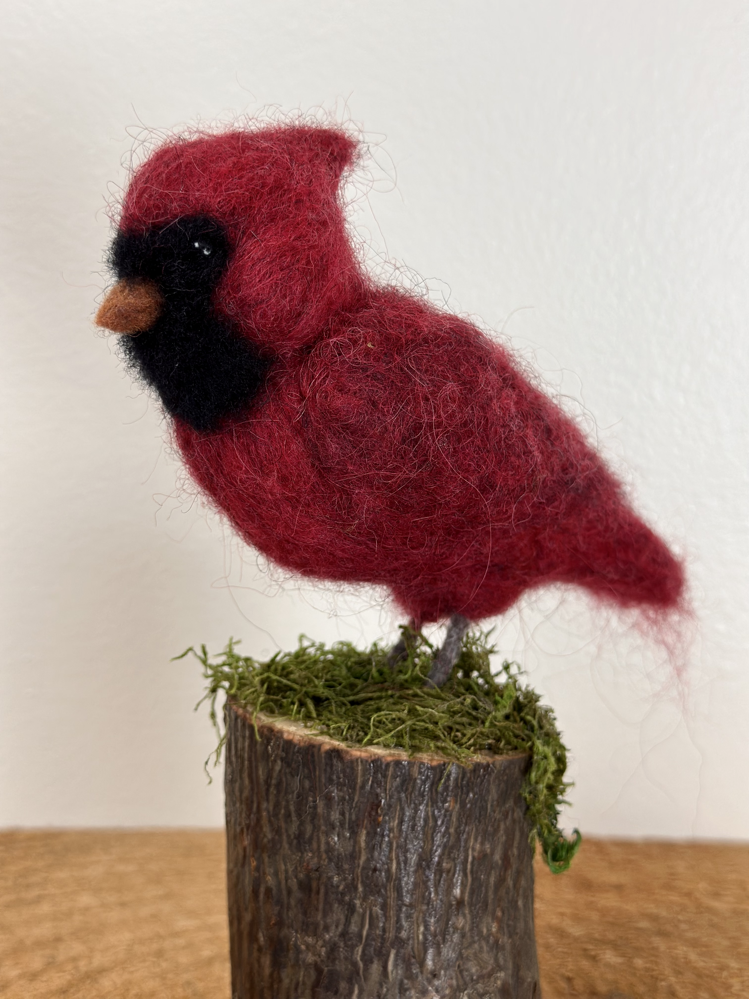 Handmade Male Cardinal, perched on a moss covered branch.