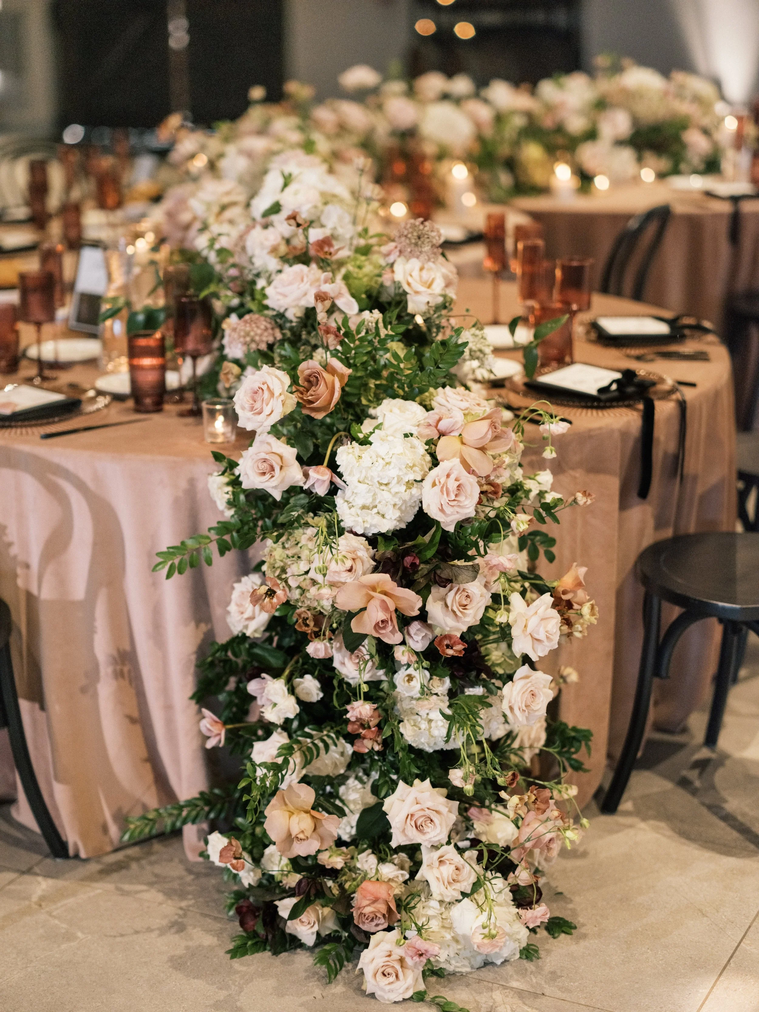 Some reception details whisper instead of shout, but they&rsquo;re often the details that make guests feel the magic without even realizing why. ✨

From the candlelit ambiance to the floral cascades flowing effortlessly from the sides of the caterpil
