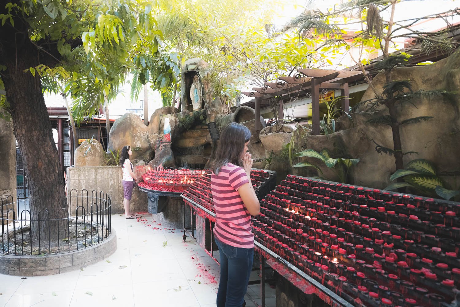 Woman Praying and Lighted Candles