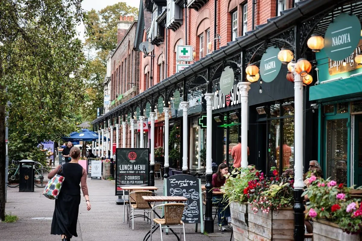 High street in Didsbury showing cafes and shops