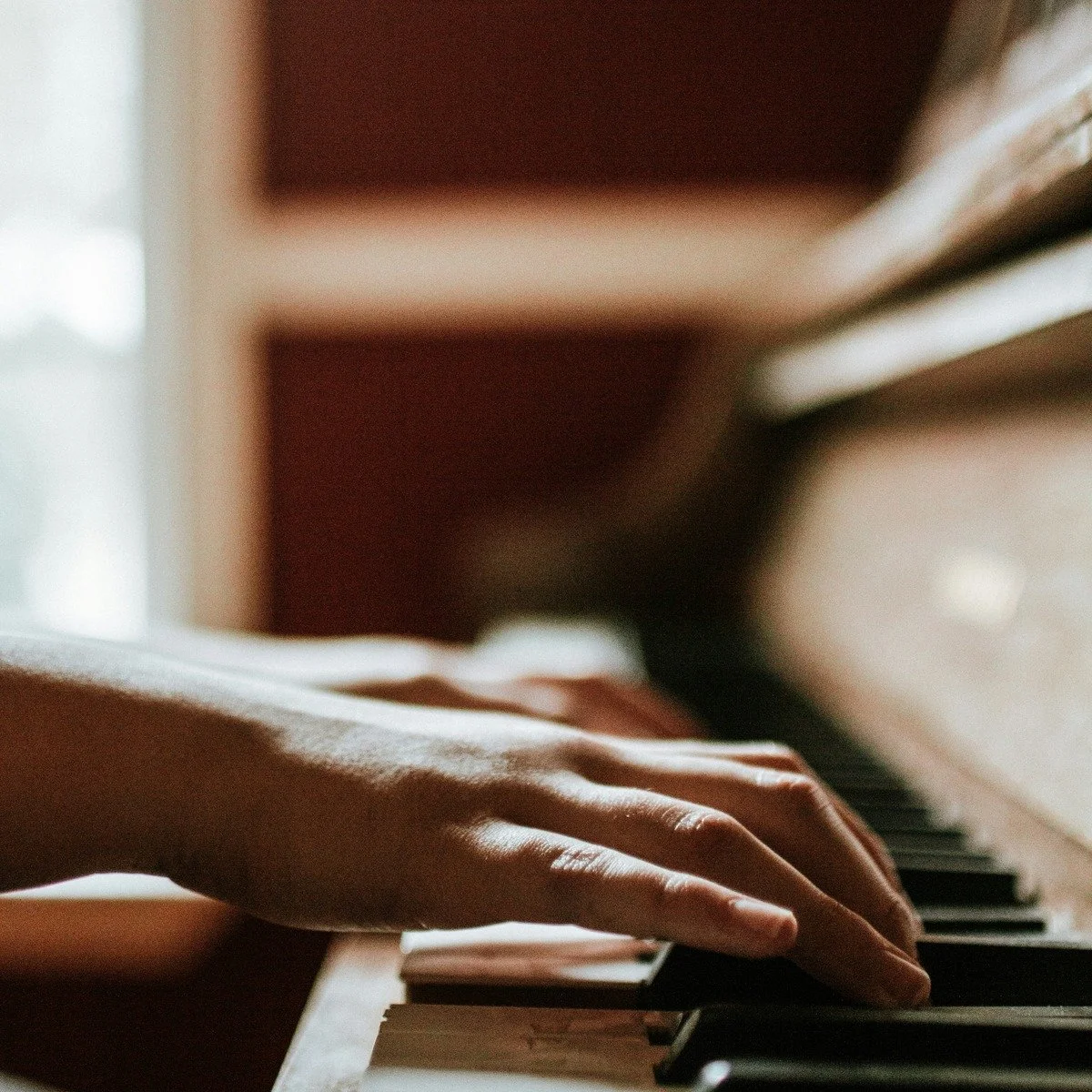 Child playing piano in piano lesson