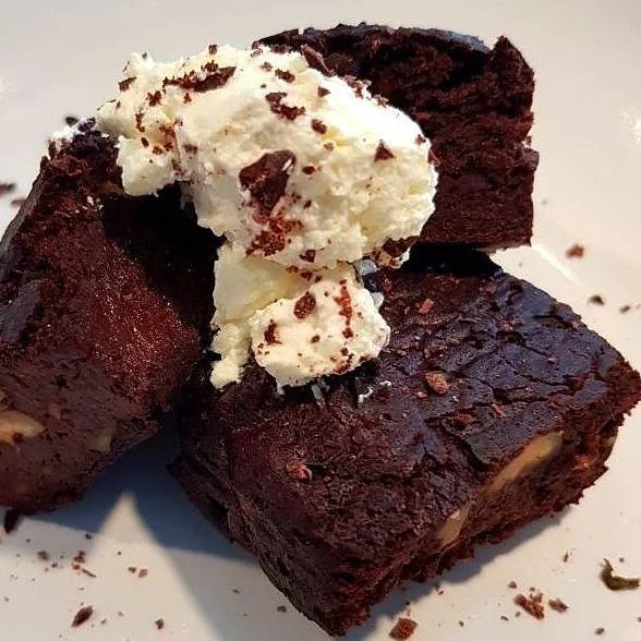 ingredients 240g black eye’d beans 50g cacao powder 20g chia seeds 1tsp baking powder 1tsp vanilla paste 75g MCT oil or coconut oil melted 100g dark chocolate chips (100% Montezuma’s) 90ml unsweetened almond milk (gently heated) 100g stevia granules 40g dry roasted hazelnuts (I make my own). Method 1. Heat the oven to 180C and line a 6X6 brownie tray with greaseproof paper. 2. Blitz the oil, milk and chia seeds into a fine paste. 3. Add the rest of the ingredients to the blender (except the hazelnuts and chocolate chips), combine everything well, scraping down the sides with a spatula to get an even batter. 4. Roughly chop the roasted hazelnuts and chocolate and then place in a medium to a bowl with the batter and combine with a wooden spoon so everything is even. 5. Spoon your brownie batter into the tray and smooth down the top with a spatula, bake on the middle shelf for 35-40 minutes. 6. Turn the oven off and leave the brownies inside while it is still warm. This cooling down period can take 3-4h hours. If you eat them while they are still hot they won’t have that classic fudge texture and you may even think they are undercooked. 7. Indulge guilt free or serve with some coconut cream! Note: Not all black beans are equal, it is important to check the fibre to carb content. As long as the fibre is higher than the carbohydrates on the nutritional information then they are good to go. Take a look at the screen shot below for an example of this.