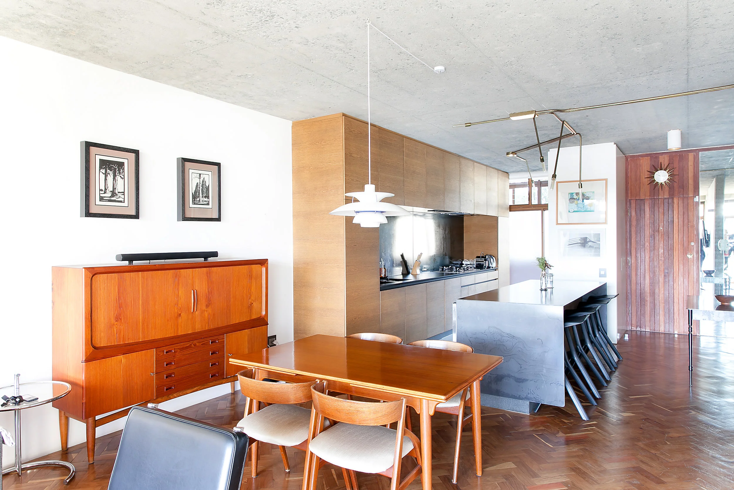 Open plan kitchen and dining space in a Johannesburg family home, oak cabinetry and parquet floors