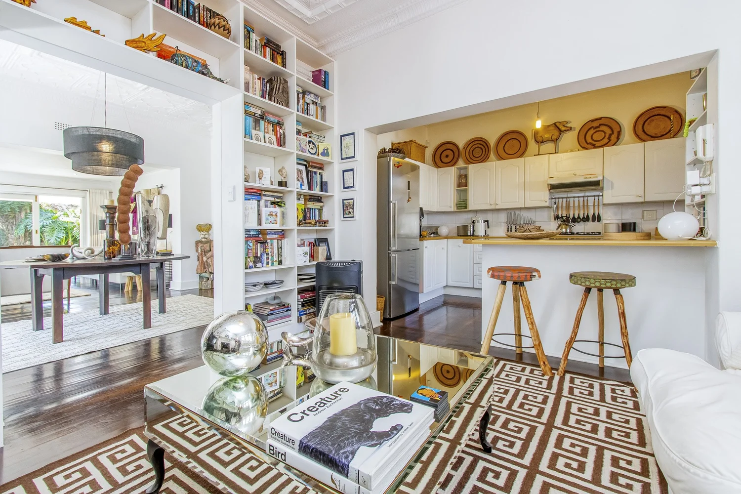 Furnished Parkhurst cottage lounge with bookshelves and kitchen