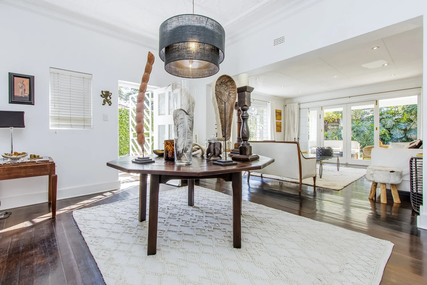 Entrance hall with round table and carved sculptures