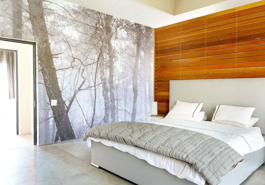 Bedroom with forest mural and timber wall