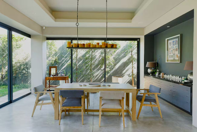 Dining area with floor-to-ceiling glass onto the trees