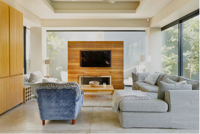 Lounge with timber feature wall and garden views