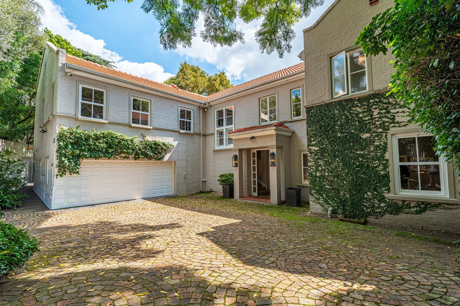 Ivy-covered family home with cobbled courtyard