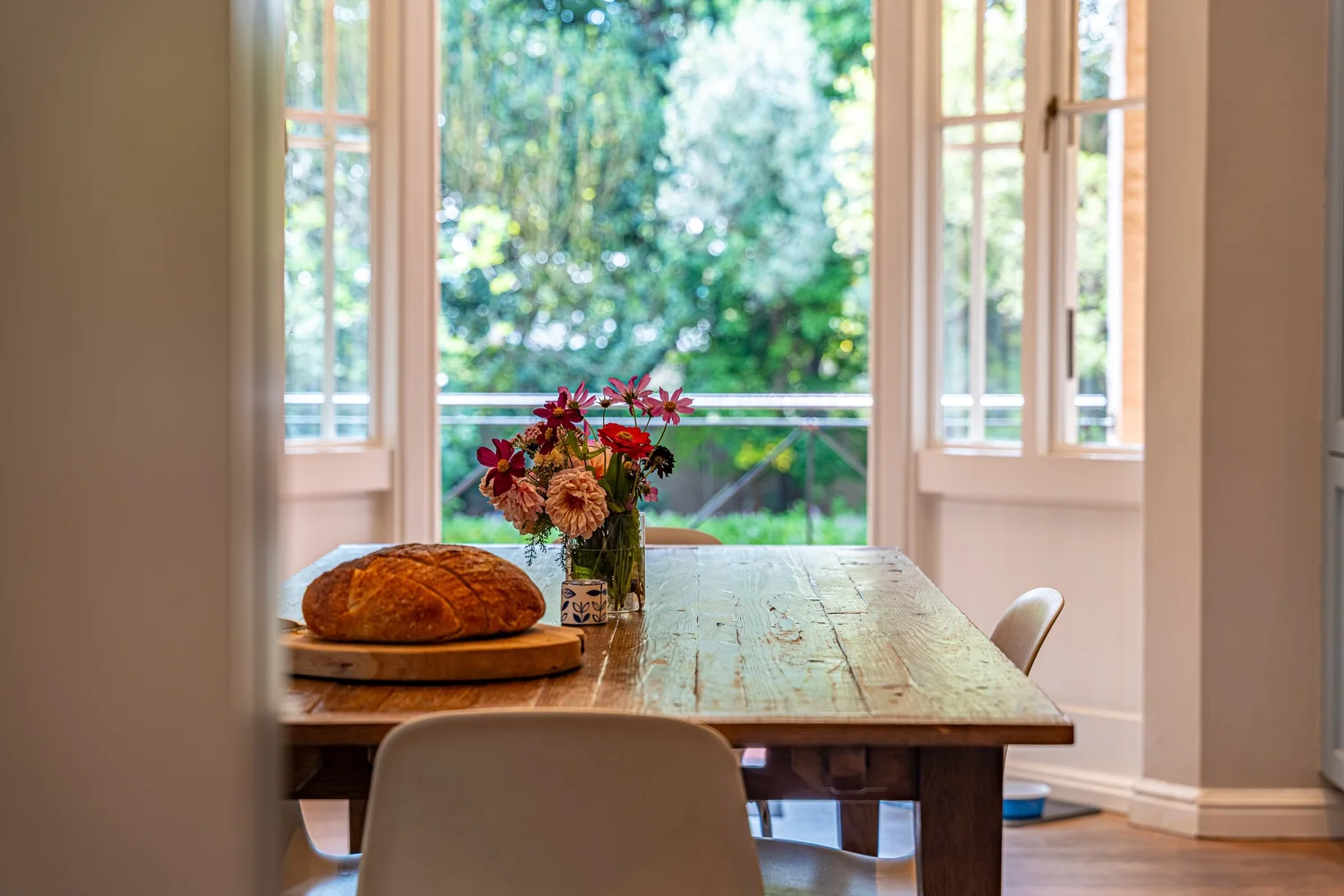 Sunlit dining table set for breakfast in a Hyde Park home