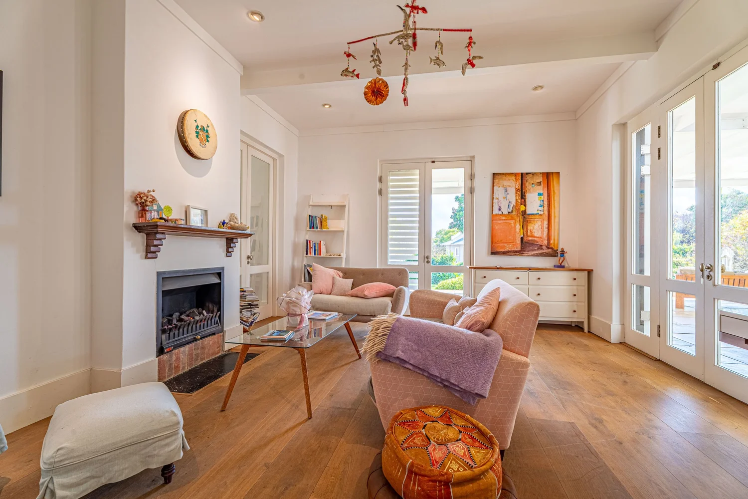 Sunlit winter lounge with fireplace and shuttered windows