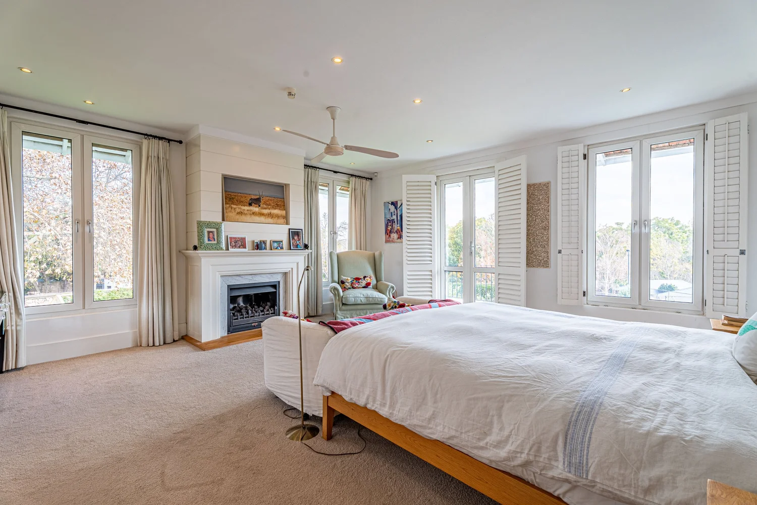 Main suite with fireplace and shuttered windows