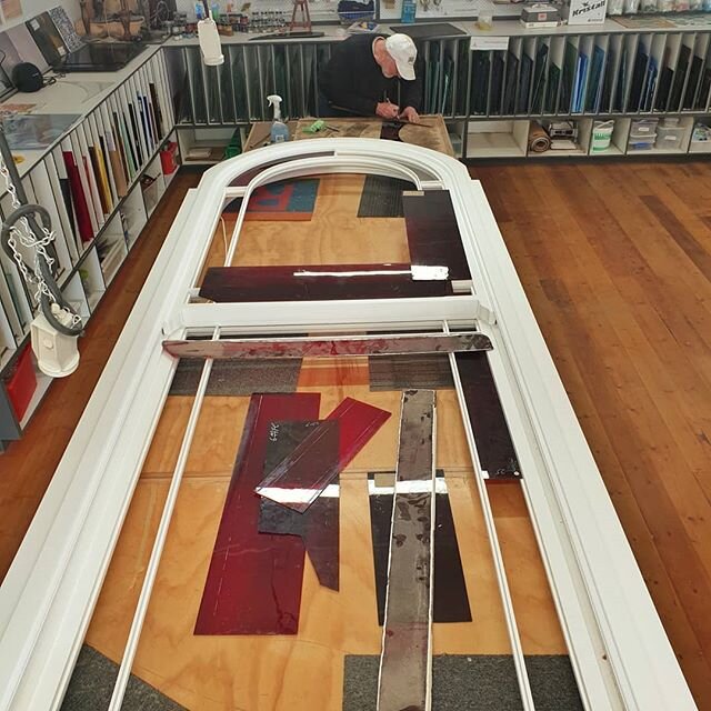 Ettore's working on adding some ruby red flashed glass and decorative cobalt blue corners to this remade window frame by @customtimberwindowsanddoors The frame is so large he needs 3 tables for the job!

#windowrestoration #historicalhomes #localtrad