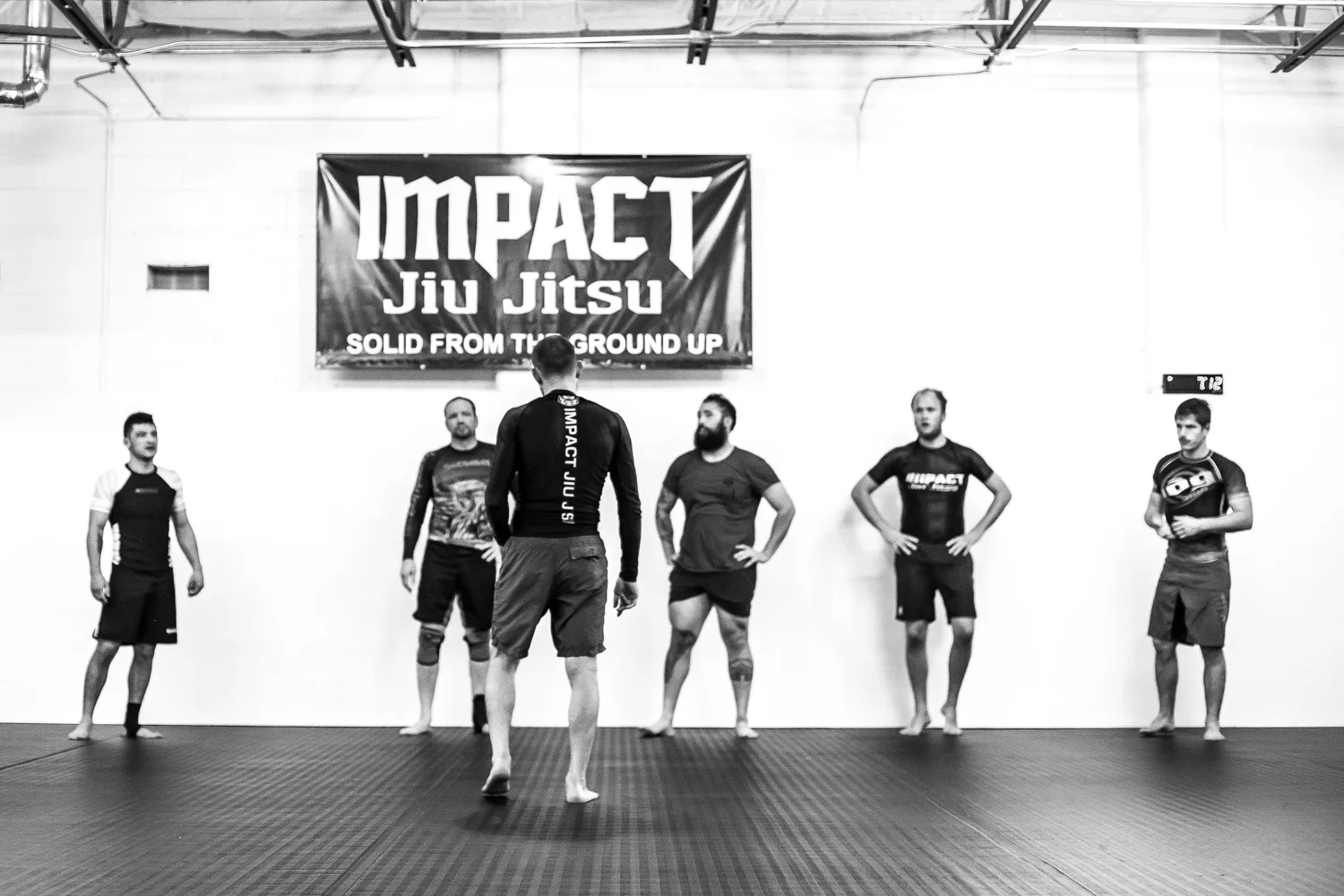 Coach Benjamin Henning teaching a No Gi grappling class at Impact Jiu Jitsu Albuquerque.