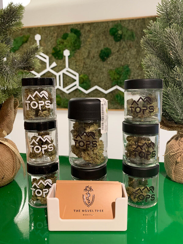 High Five Farms TOPS - This flower give people an extraordinarily economical alternative to high priced indoor cannabis. These sun grown kolas are packed with intense terpenes and stunningly high cannabinoid percentages. The growers at High Five believe that their sustainable outdoor method produces a product that is comparable to the finest indoor flower. Offerings like Beach Wedding hammer their point home. Available in eight and quarter ounces, this Oni Seed Co. classic contains a whopping 26.4% total cannabinoids. The tropical smoke produced by these dense buds is a full body relaxant that melts muscle cramps and sooths neuropathic pain.
