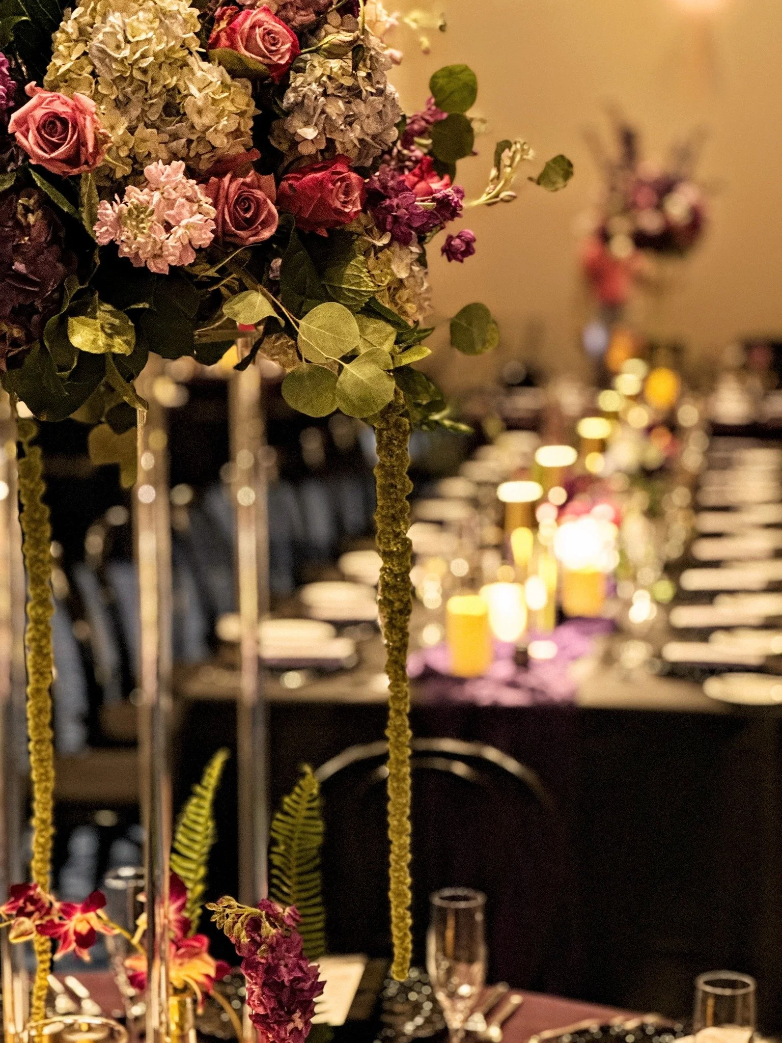 Dark. Dreamy. Unforgettable.

This moody, gothic-inspired celebration was born from a couple with bold imagination and a love story unlike any other.

Proud to bring their vision to life with sculptural florals in purples and pinks, black linens, and