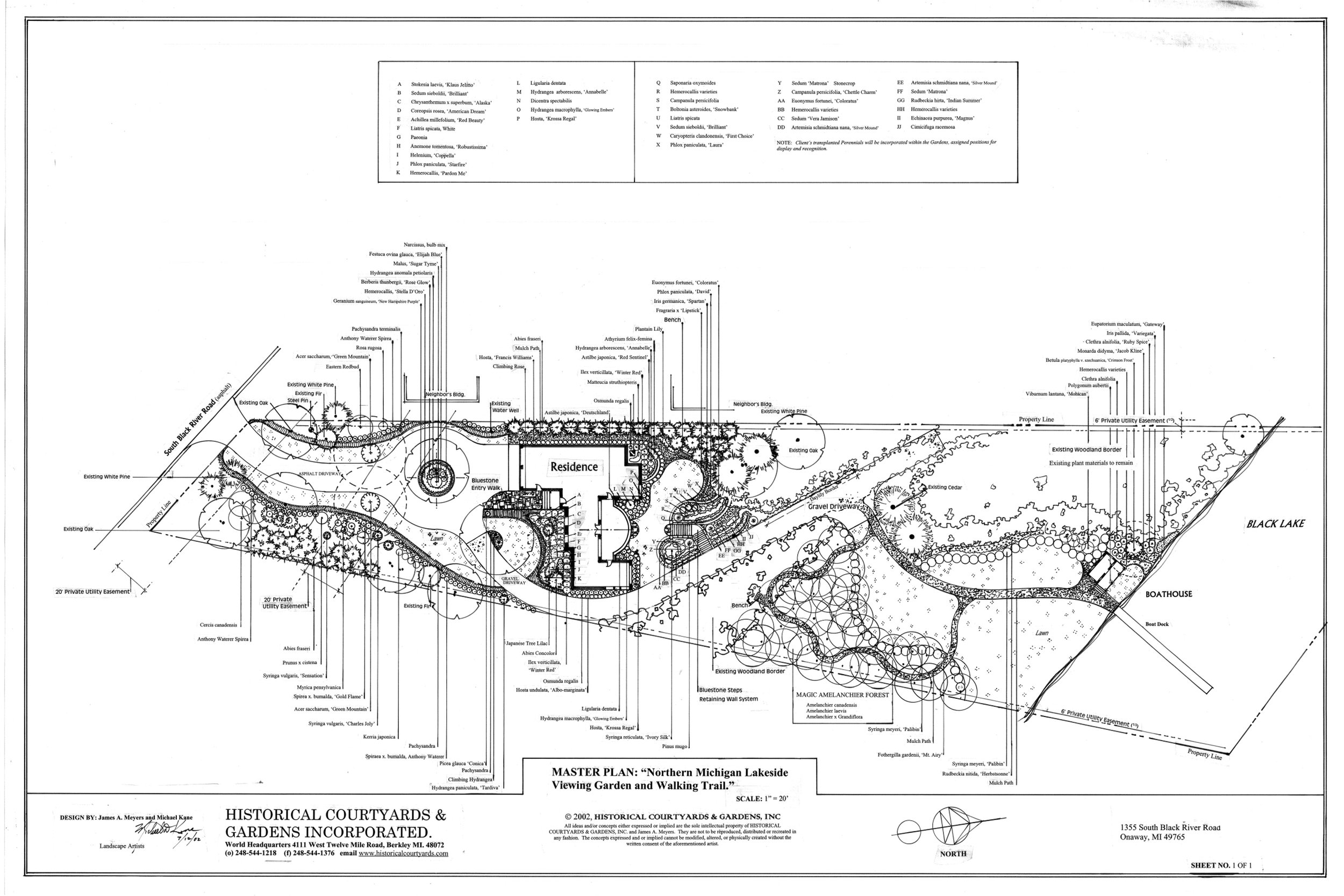 Perched on a Black Lake bluff, this landscape uses stone walls and stairs to guide you down to a lakeside boathouse amidst native evergreens.