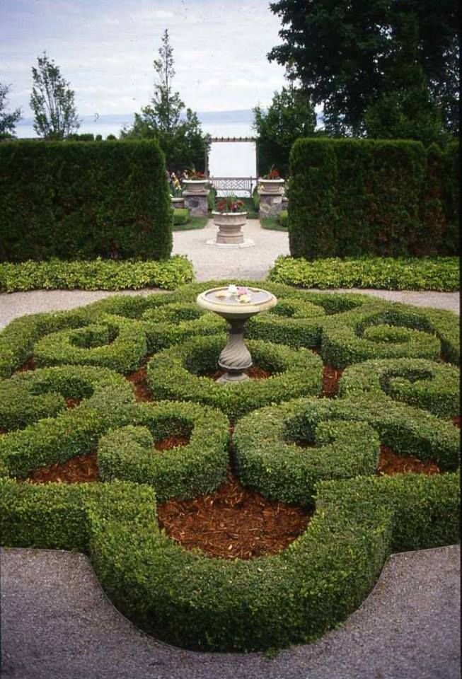  A formal parterre garden featuring boxwood hedges in a swirling pattern with a sundial Petoskey Michigan  Metro Detroit Landscaping  Southeast Michigan Landscaping  Residential Landscaping  Garden Design 