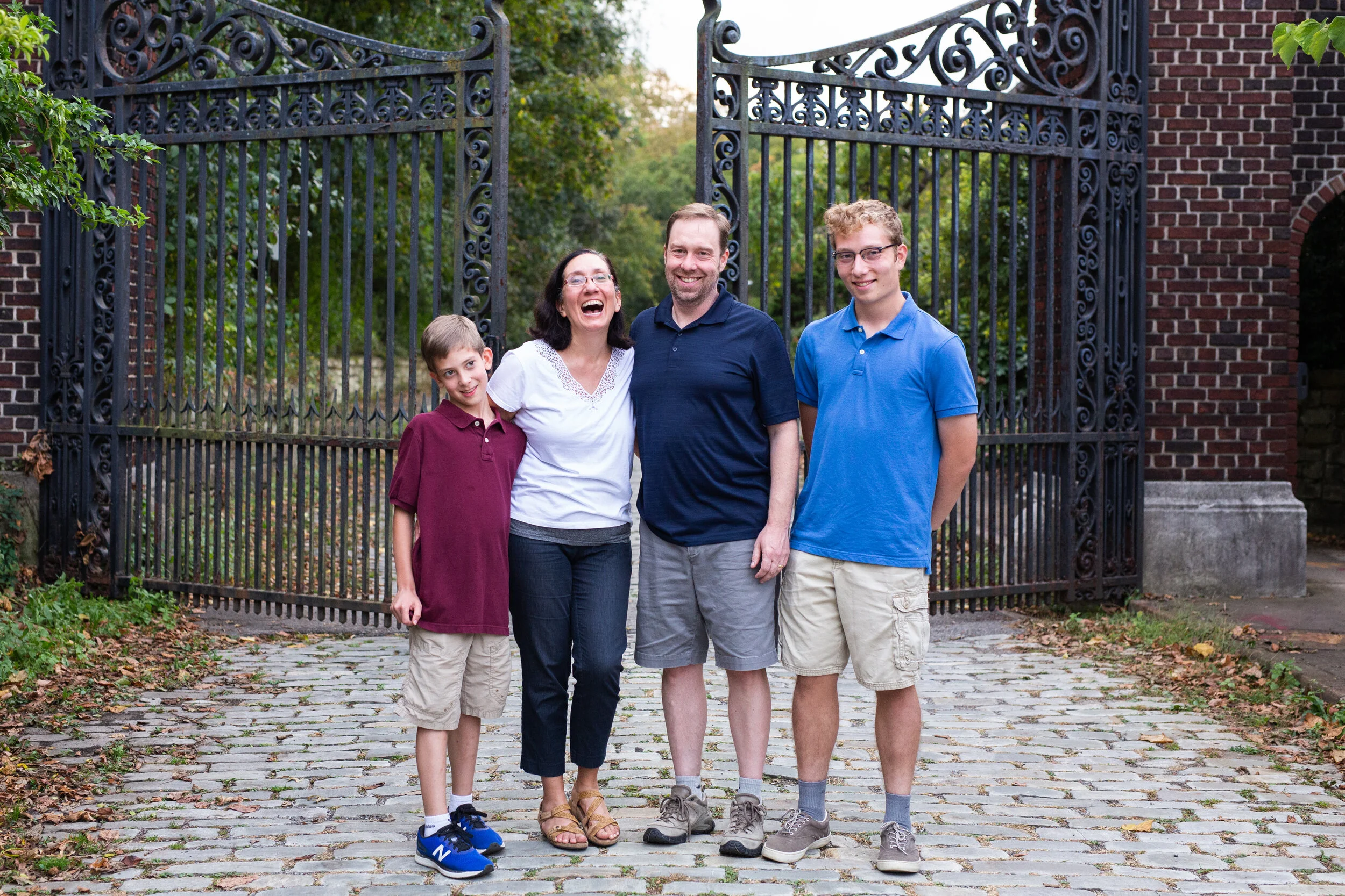 Parents and their teenage sons smile and laugh