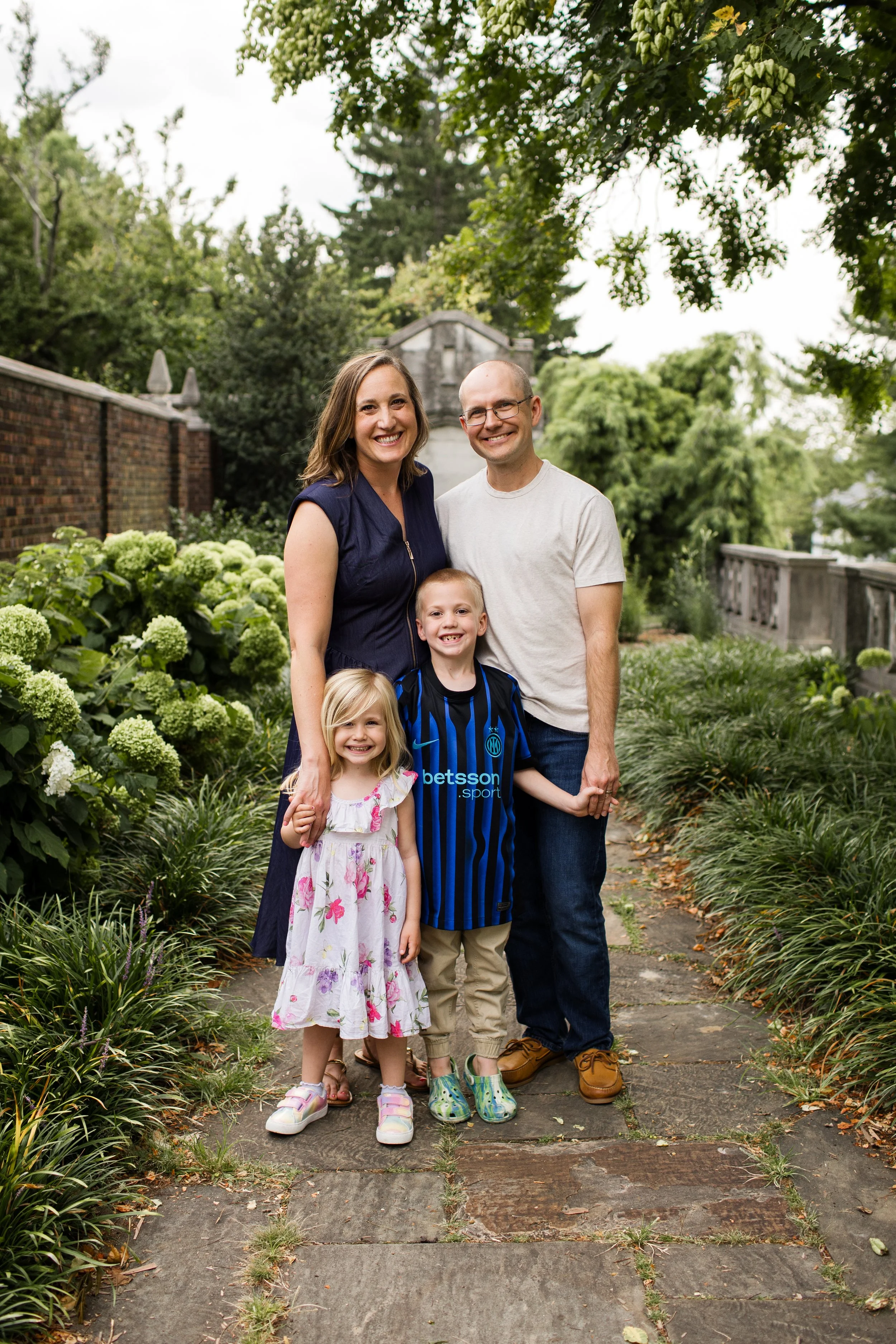 A family looks at the photographer and smiles for a family portrait at Mellon Park in Pittsburgh