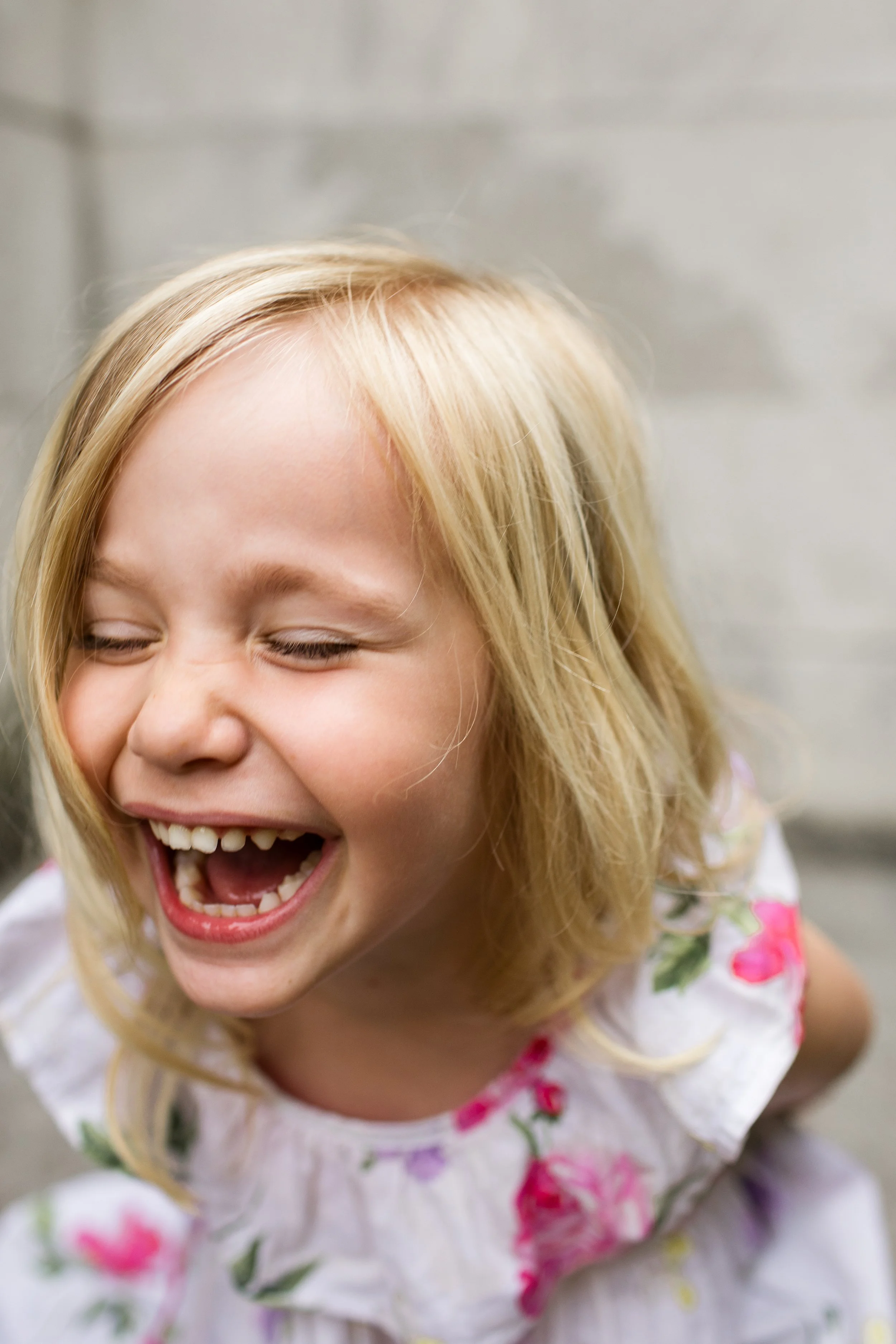 A little girl joyfully laughs at something