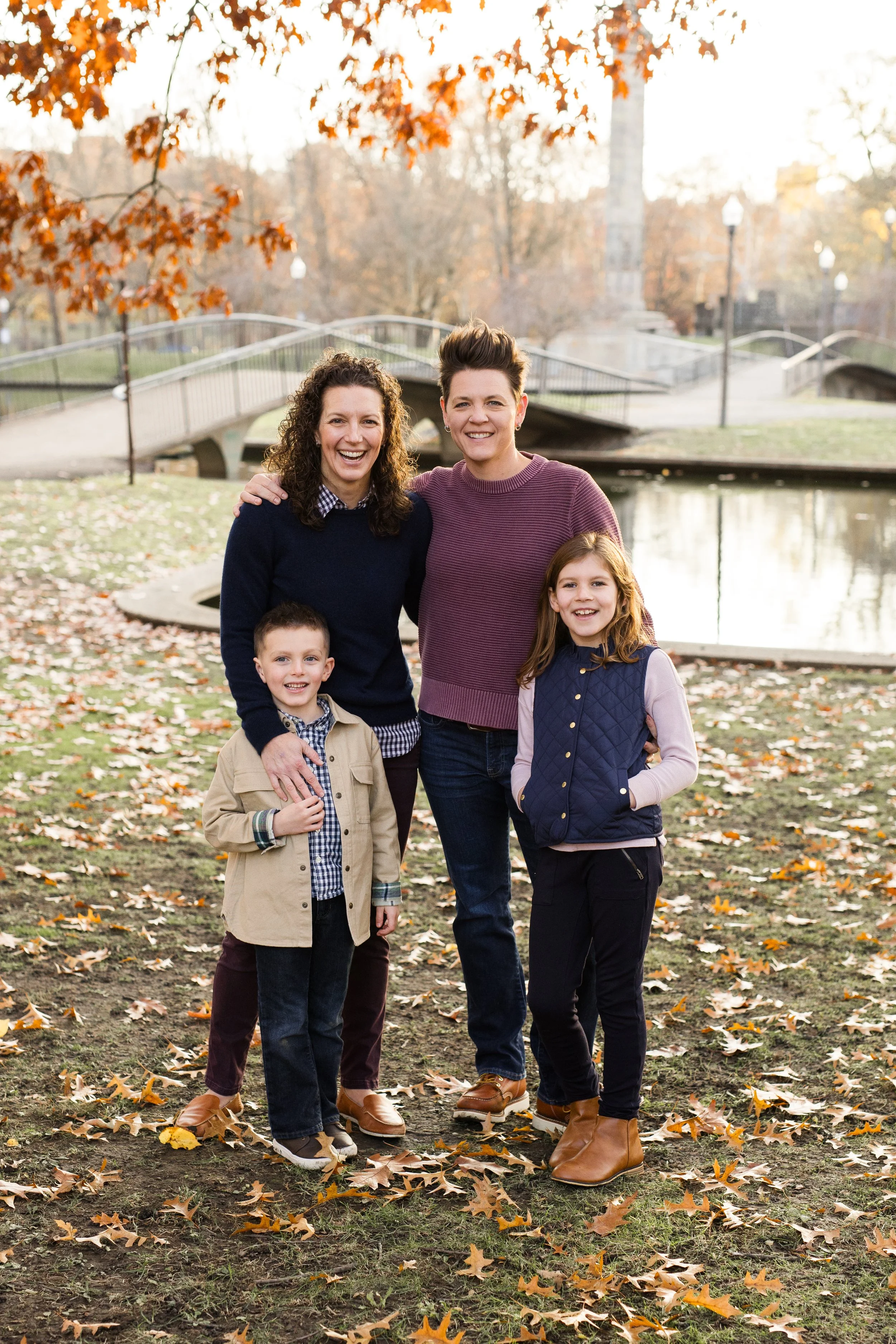 Moms and their kids stand in front of Elizabeth Lake in Pittsburgh and the beautiful footbridges