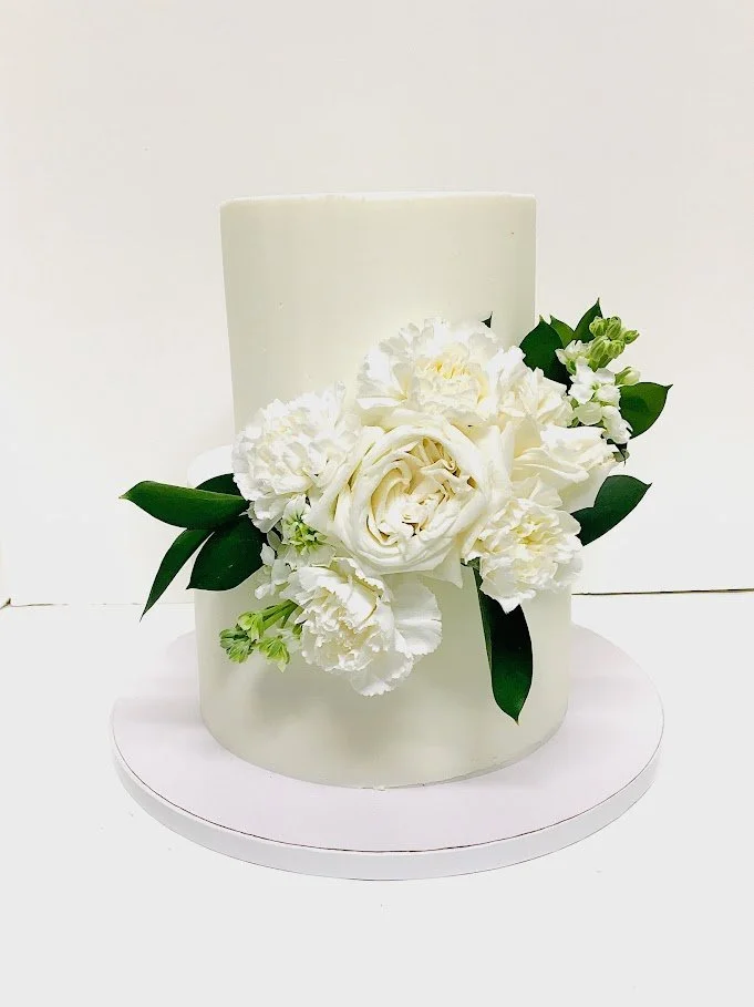 white solid with white flowers in front.jpeg