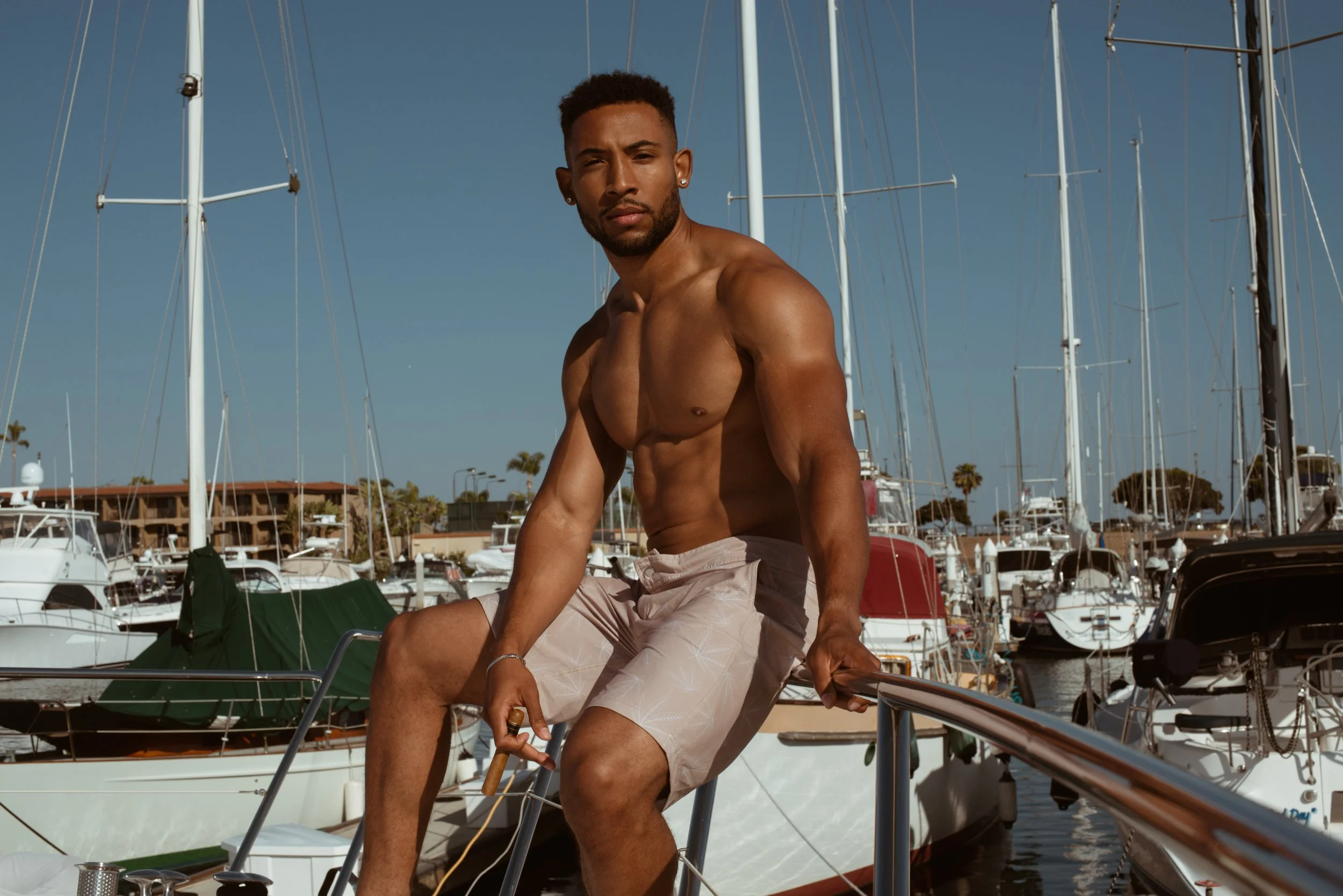  Men’s swimwear and lifestyle shoot with model on sailboat in California marina, photographed by Kristina Yamamoto for San Diego Swim Week 
