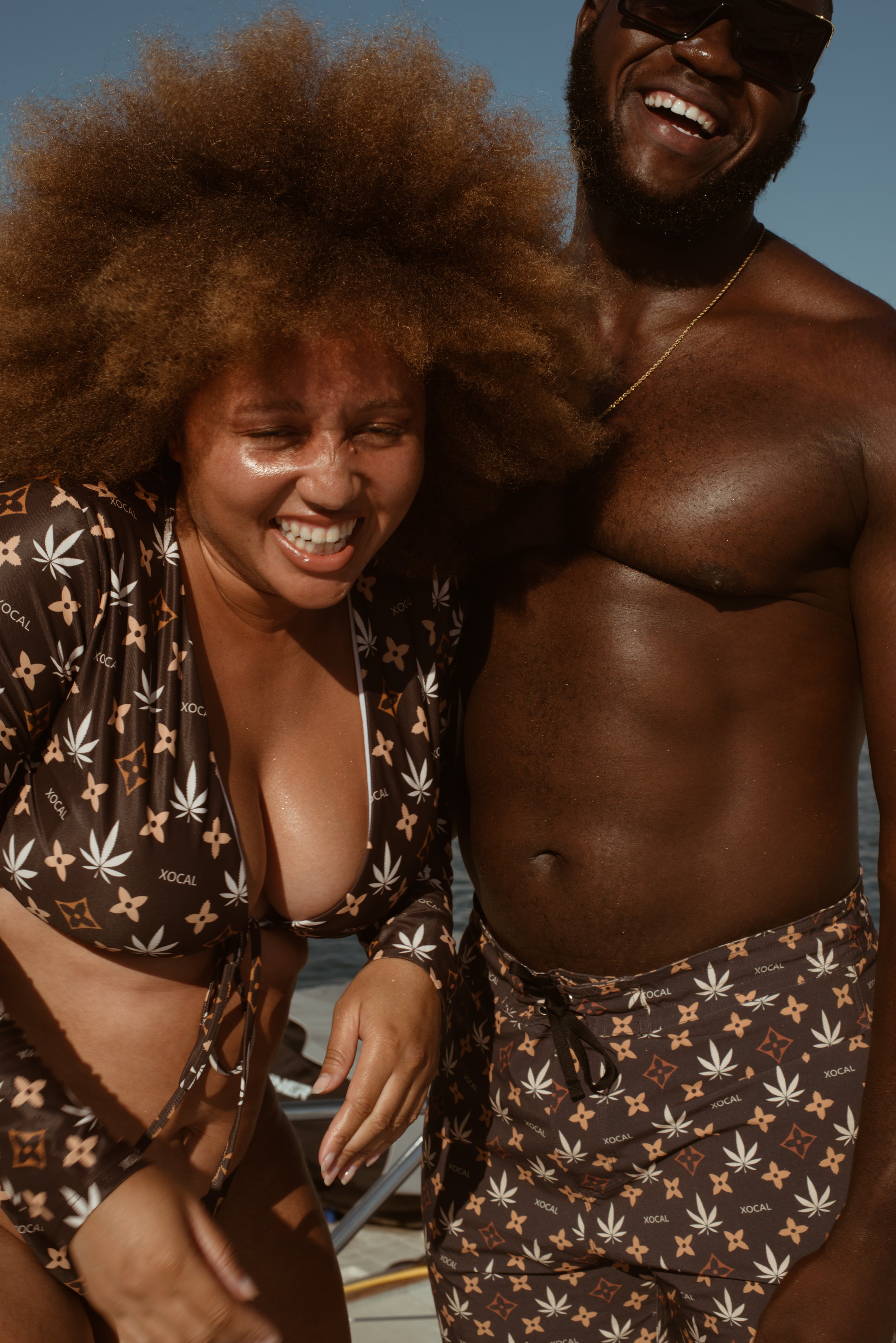  Playful commercial image of two models in coordinating star print swimwear sharing a moment 