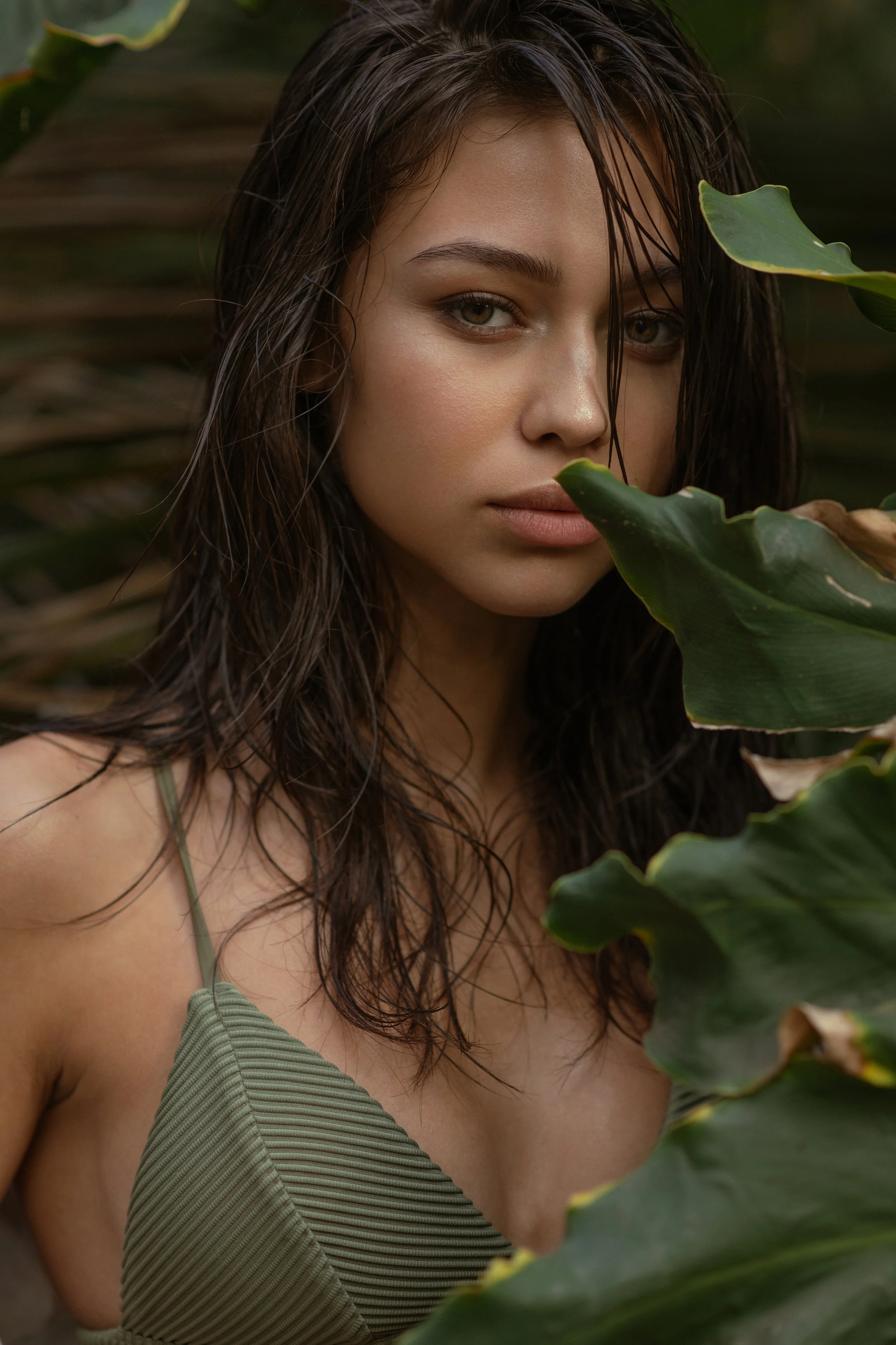  Beauty-focused swimwear portrait with wet-look styling and lush greenery, photographed on location in California 