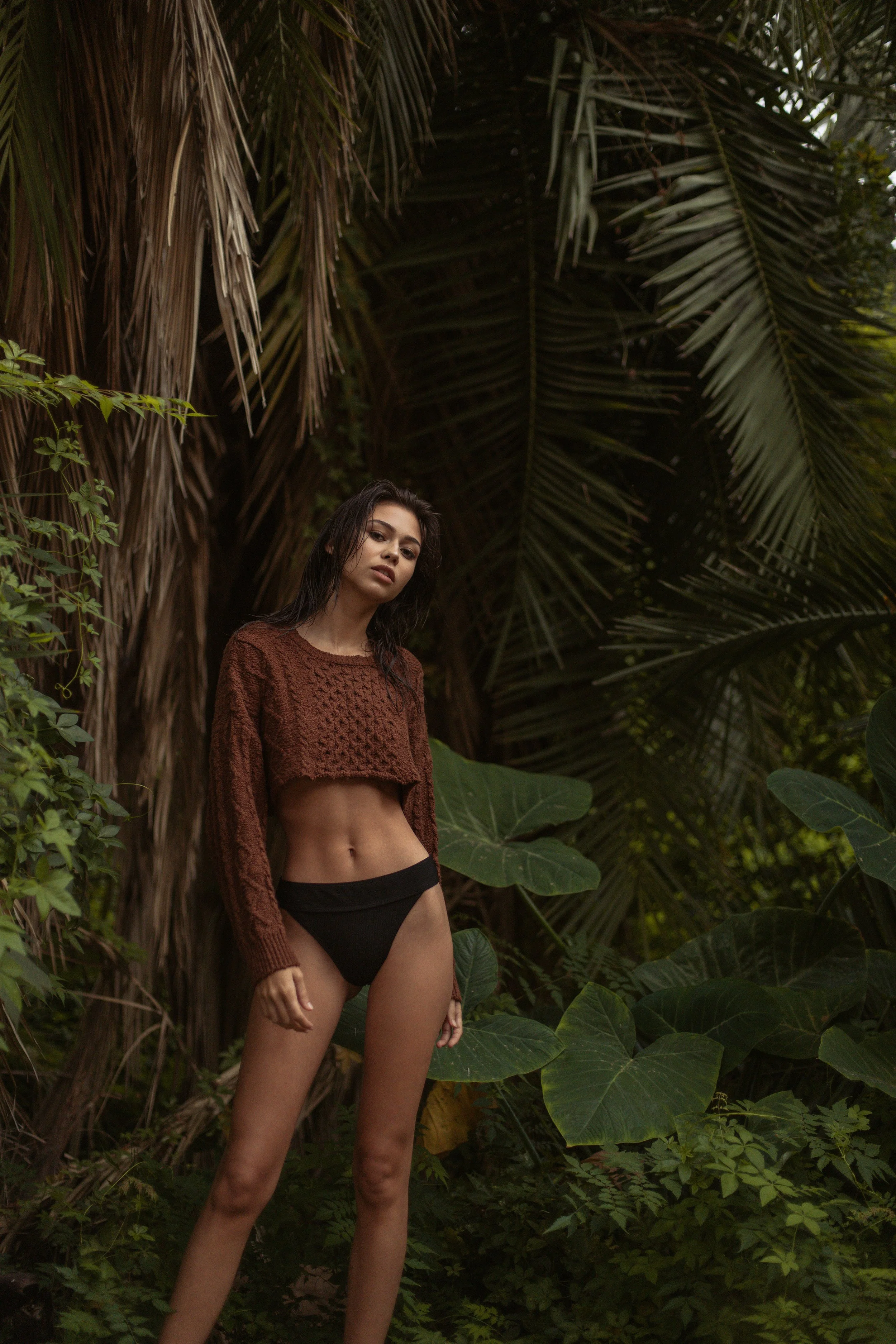  Jungle-inspired editorial portrait with natural light and rich texture, part of tropical swimwear campaign 