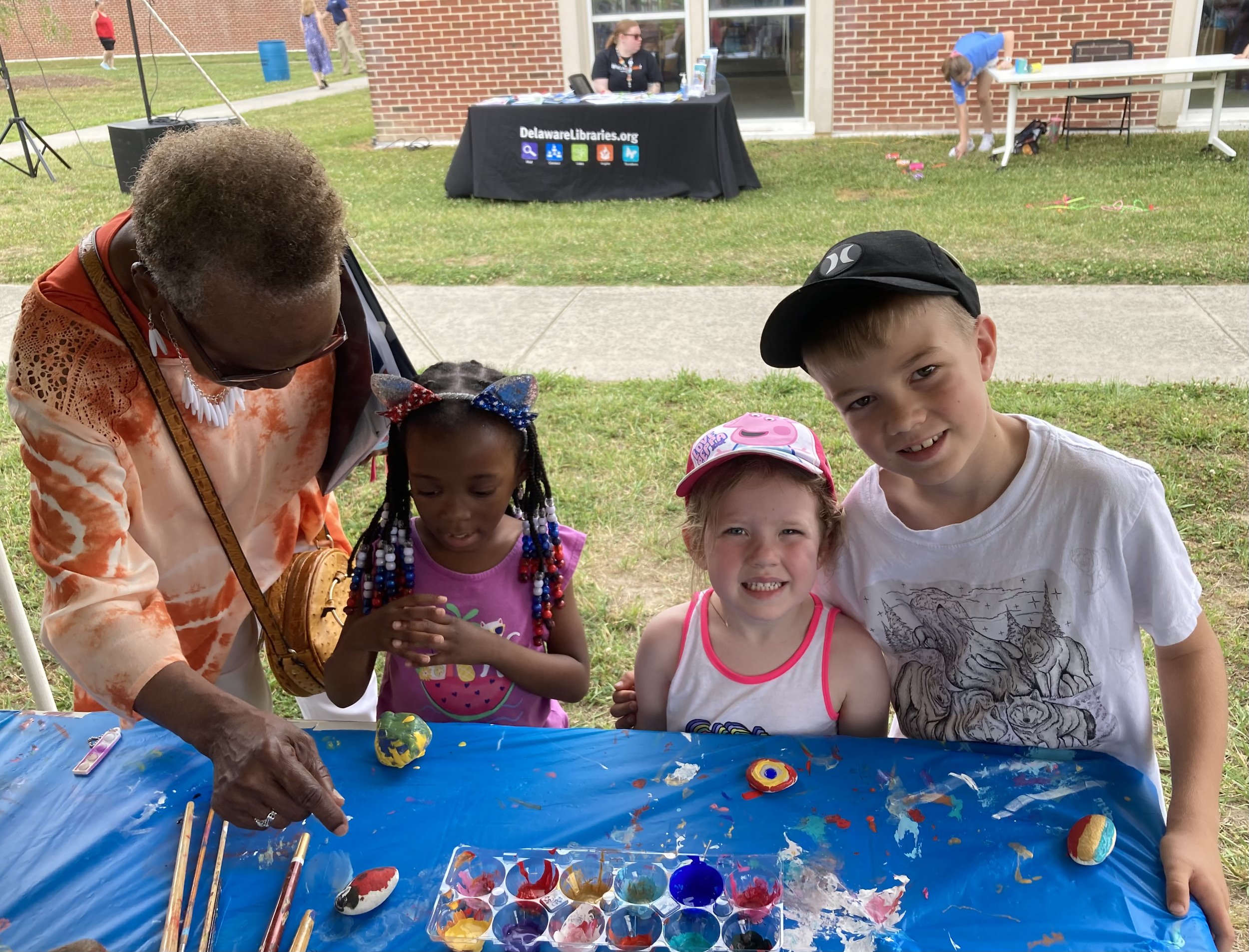 Community members explore peace art and resources for nonviolence at Nonviolent Seaford’s table at the Seaford Public Library’s Summer Reading Program Kick-off
