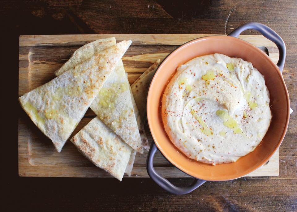 The secret to our hummus? Lemon oil. And lots and lots of warm flatbread.