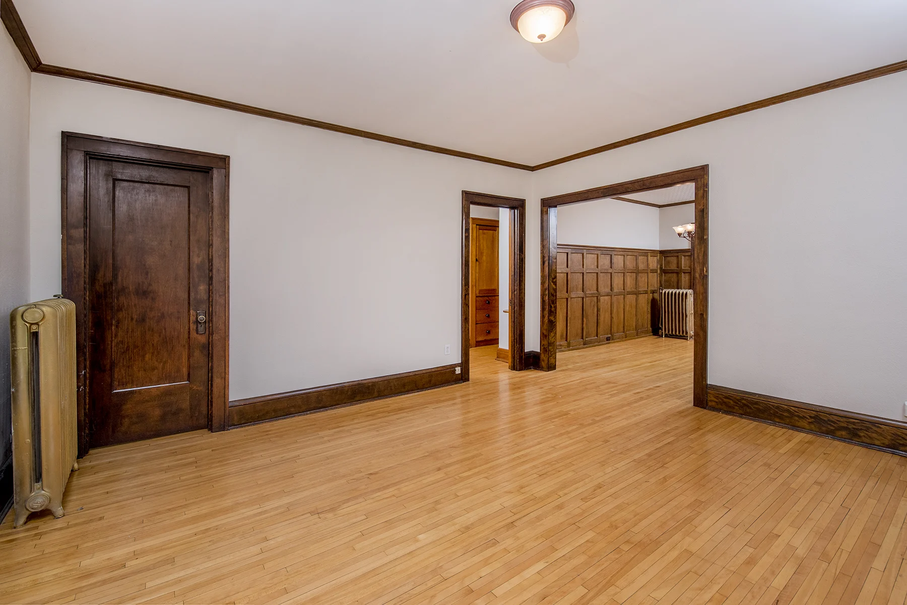 Spacious living room with lots of windows welcomes you in.