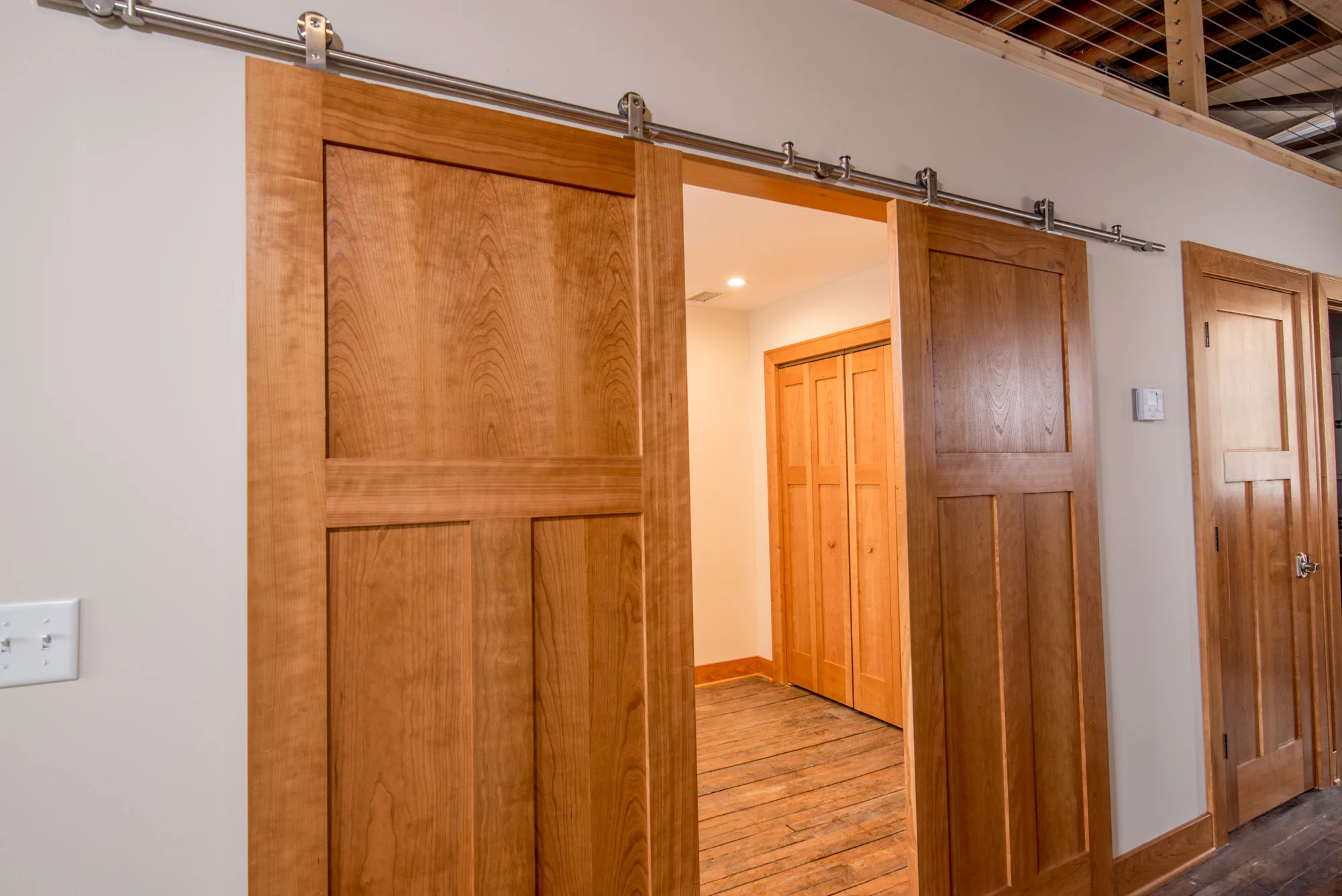 Barn doors offer full privacy in some of the building's units
