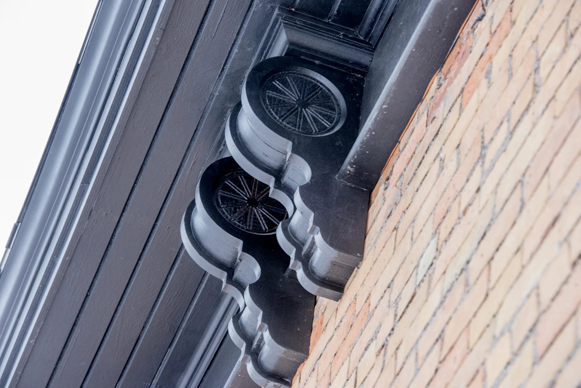 In honor of the building's history, wagon wheel detailing on the cornice around the exterior of the building