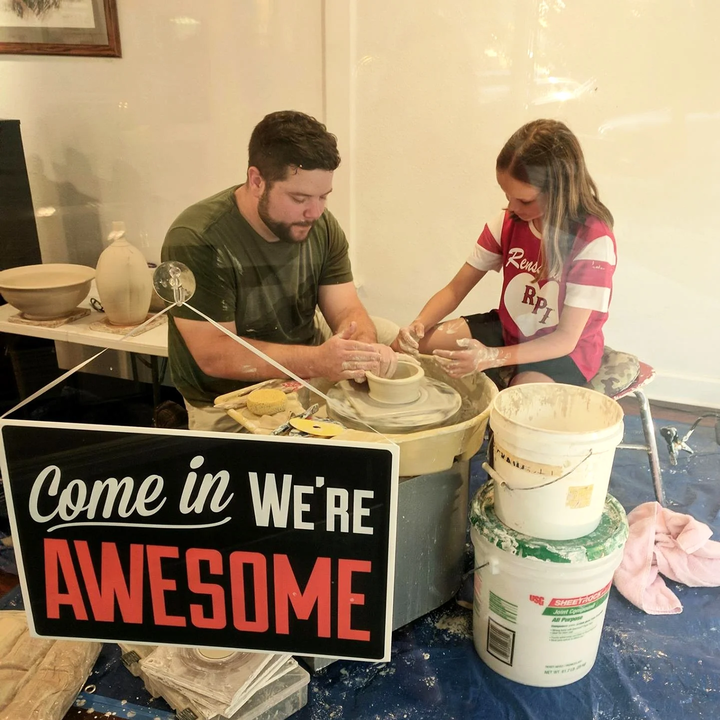 Geno Boni of Mudslide Pottery offering a pottery throwing demonstration in the ECCOTA Gallery window.